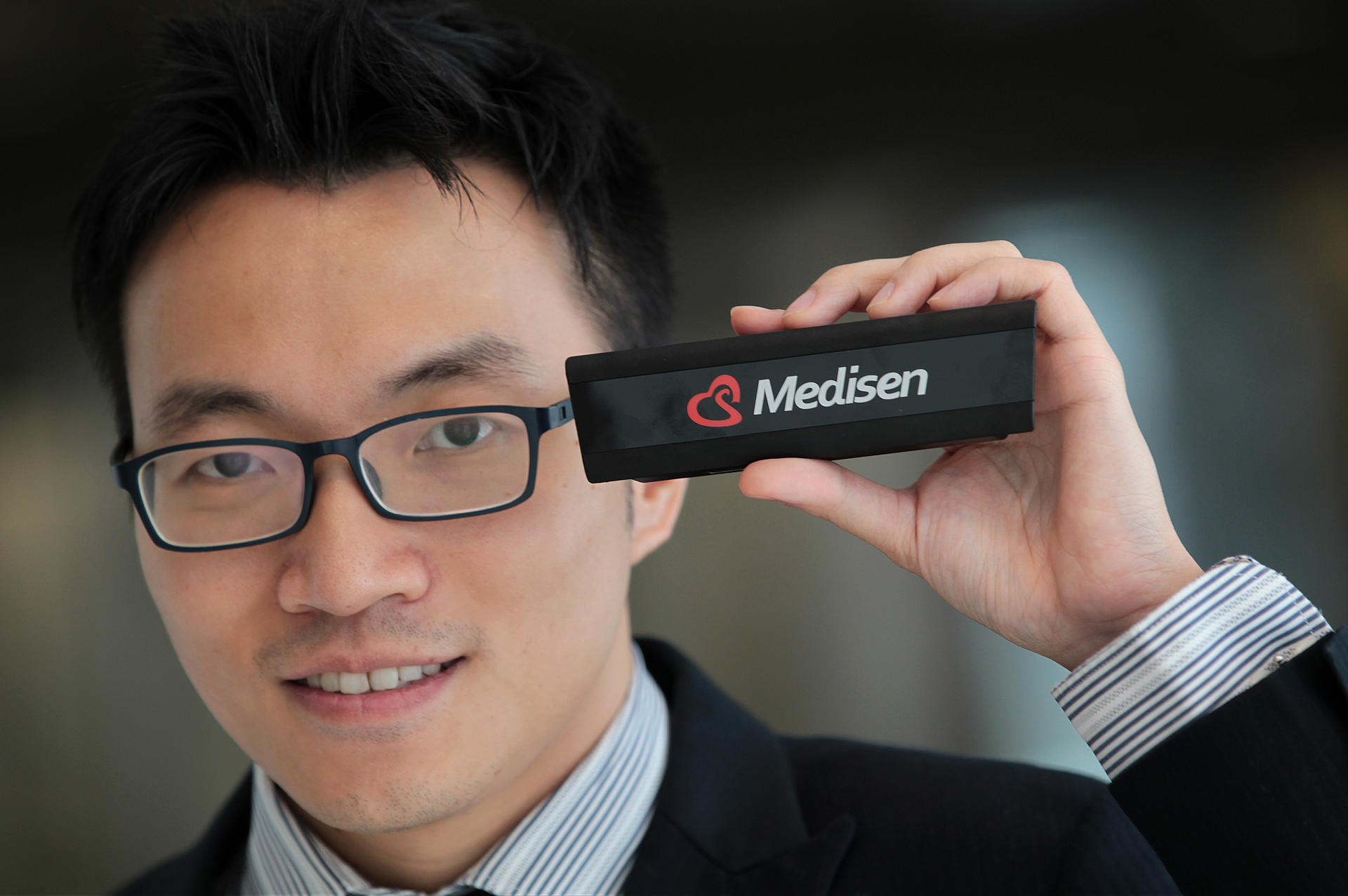 Medisen Limited's Joe Wong with the "video stick". Photo: Bruce Yan