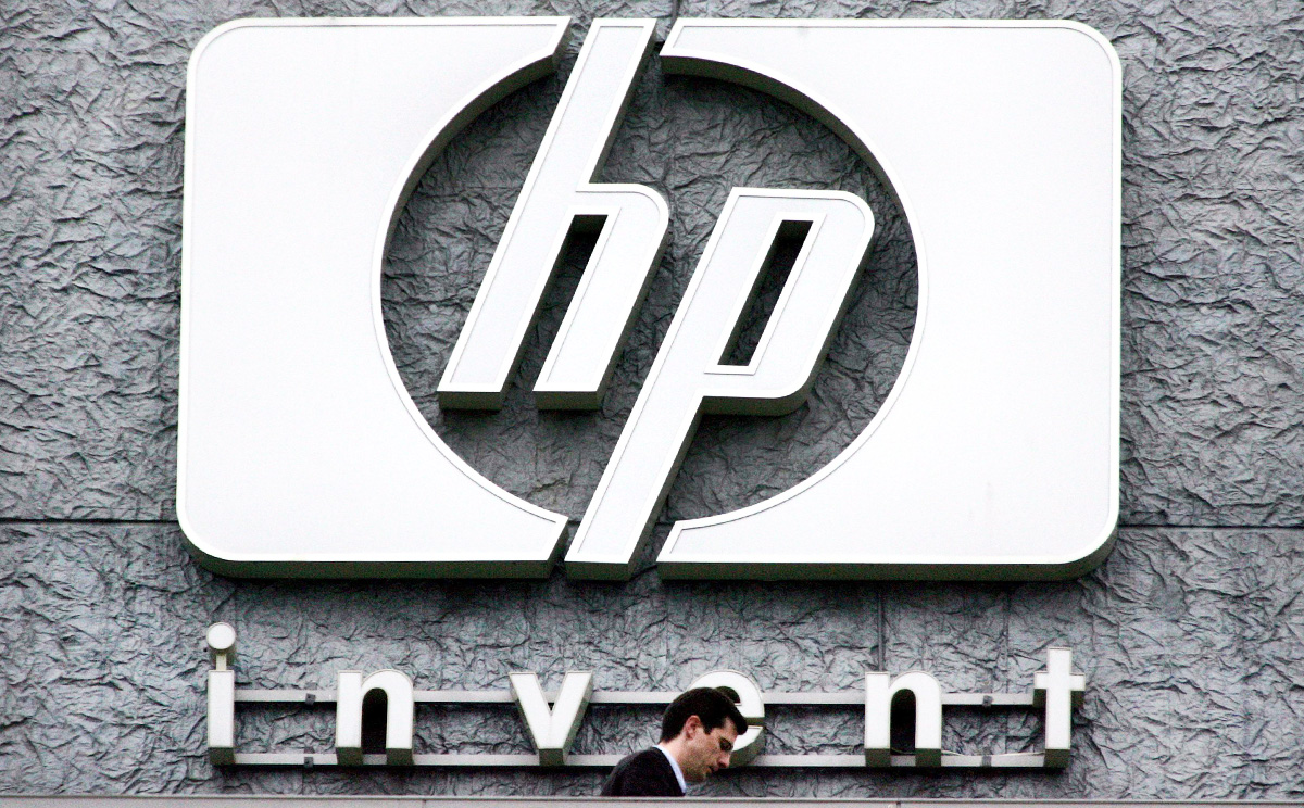 A man walks past the Hewlett Packard logo at its French headquarters in Issy le Moulineaux, western Paris. Photo: Reuters