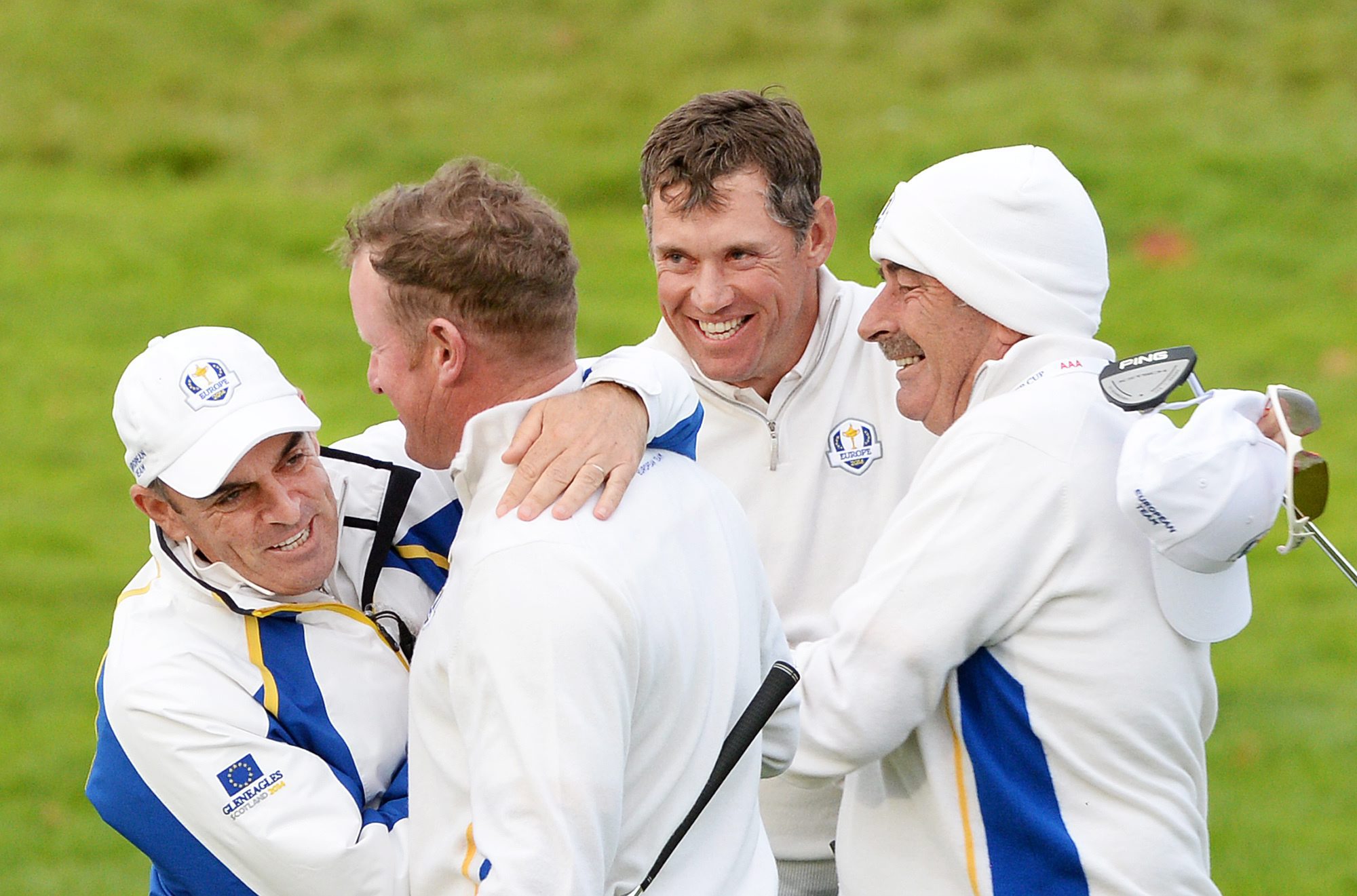 Captain Paul McGinley hugs Jamie Donaldson while teammate Lee Westwood  is congratulated by vice captain Sam Torrance  after winning their foursomes match against Matt Kuchar and Zach Johnson. Photo: EPA