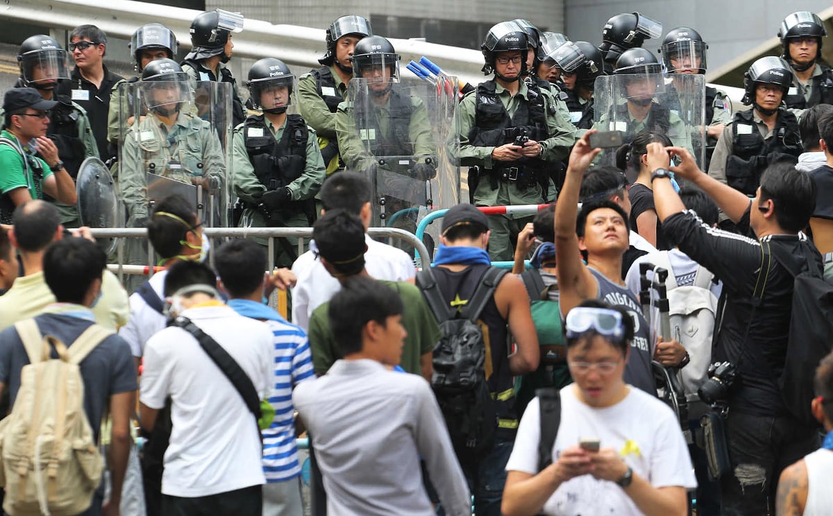 Riot police with shields guard a street in Admiralty around noon on Monday. Photo: David Wong