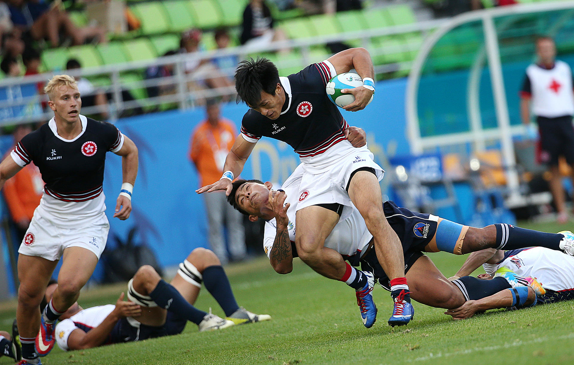 Hong Kong's Salom Yiu Kam-shing fends off a Philippines tackler in their pool game at the Namdong Asiad Rugby Field in Incheon. Photos: Nora Tam/SCMP