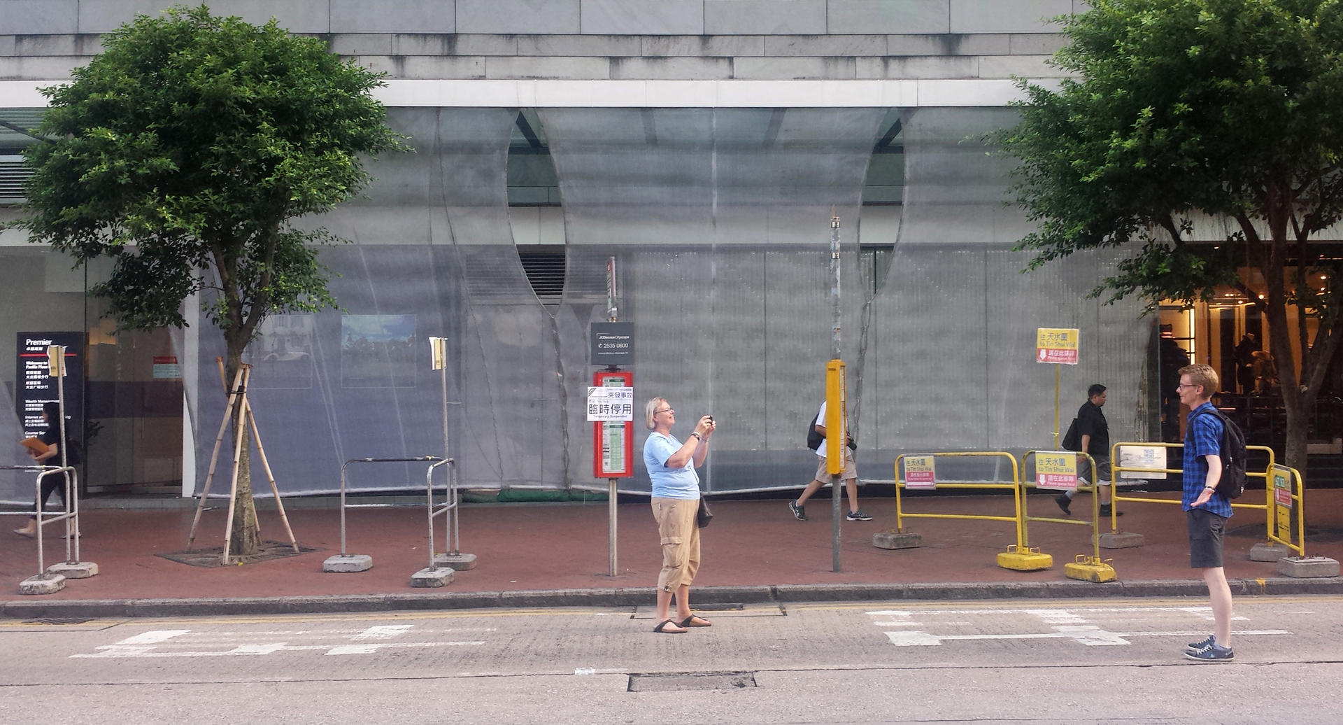 People pose for photos on an empty Queensway, which is blocked to traffic. Photo: Tiffany Ap