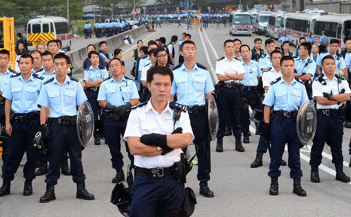 Police officers face pro-democracy protesters on Friday. Photo: AP