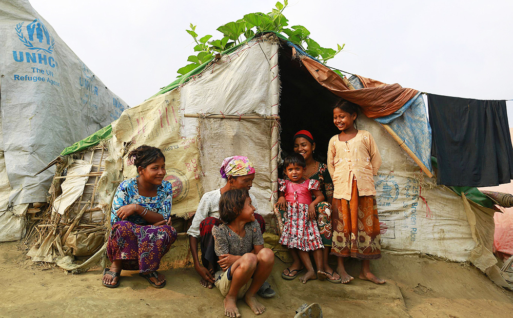 A family sits in front of their temporary shelter at a Rohingya refugee camp in Sittwe during Myanmar's  national census in April. Photo: Reuters