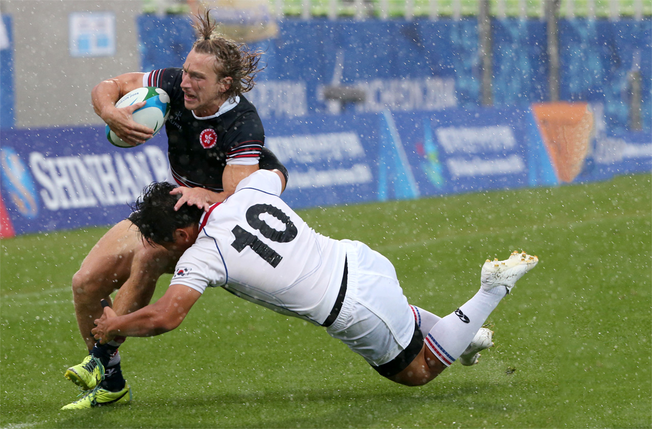 Tom McQueen is tackled by Kim Nam-uk of South Korea during Thursday’s Asian Games men’s semi-finals match at the Namdong Asiad Rugby Field in Incheon. Hong Kong won the semi 15-7, but lost the gold medal final against Japan 12-24. Photo: Nora Tam/SCMP

