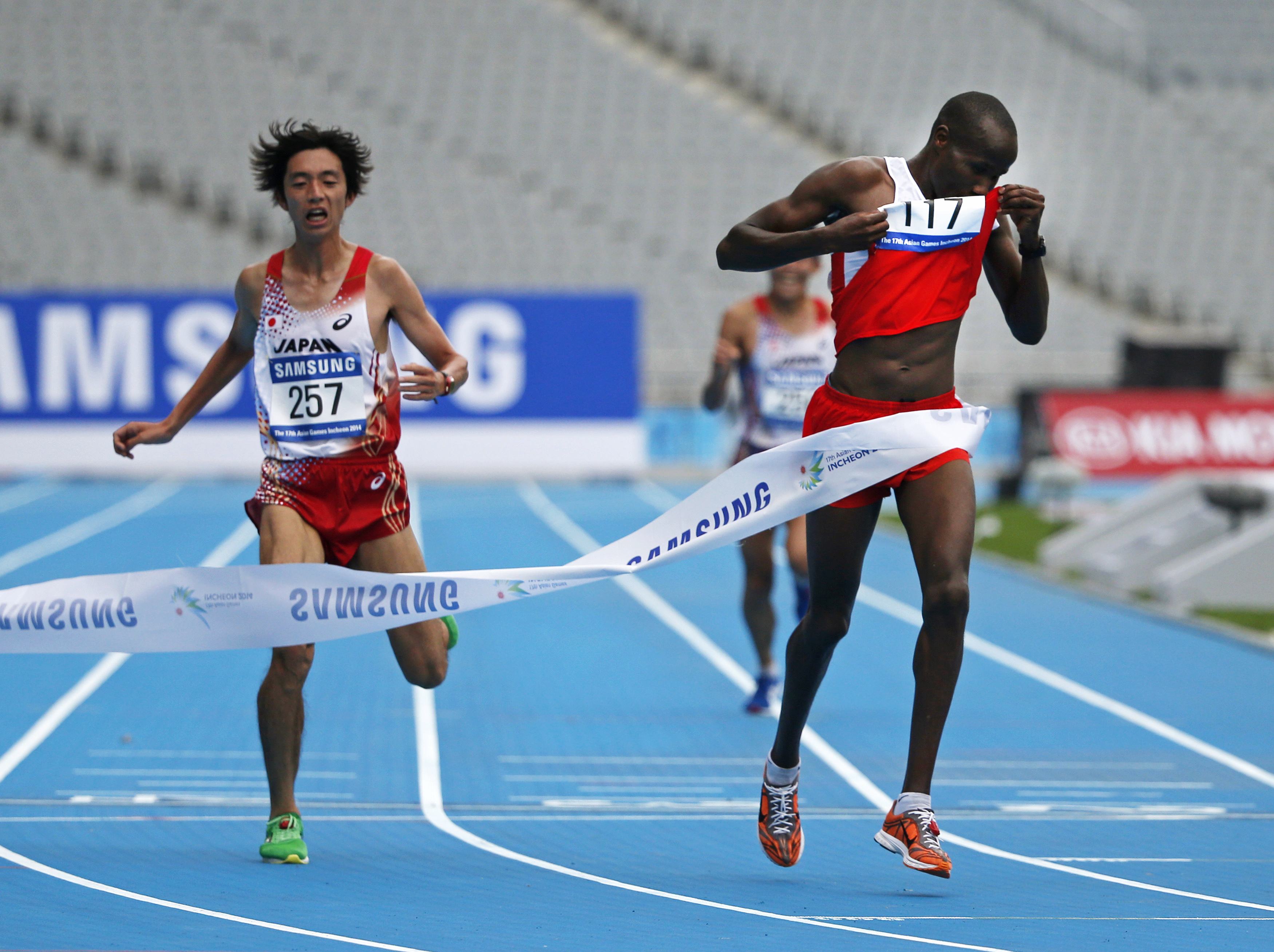 Bahrain's Ali Hasan Mahboob wins the men's marathon in front of a near empty stadium in Incheon. Photo: Reuters
 