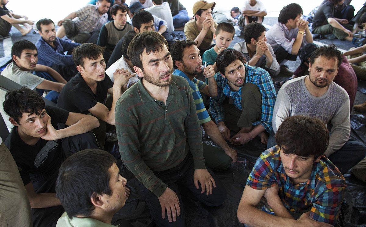 Suspected Uygurs from Xinjiang sit inside a temporary shelter after they were detained near the Thailand-Malaysia border in this file picture from March. Photo: Reuters 