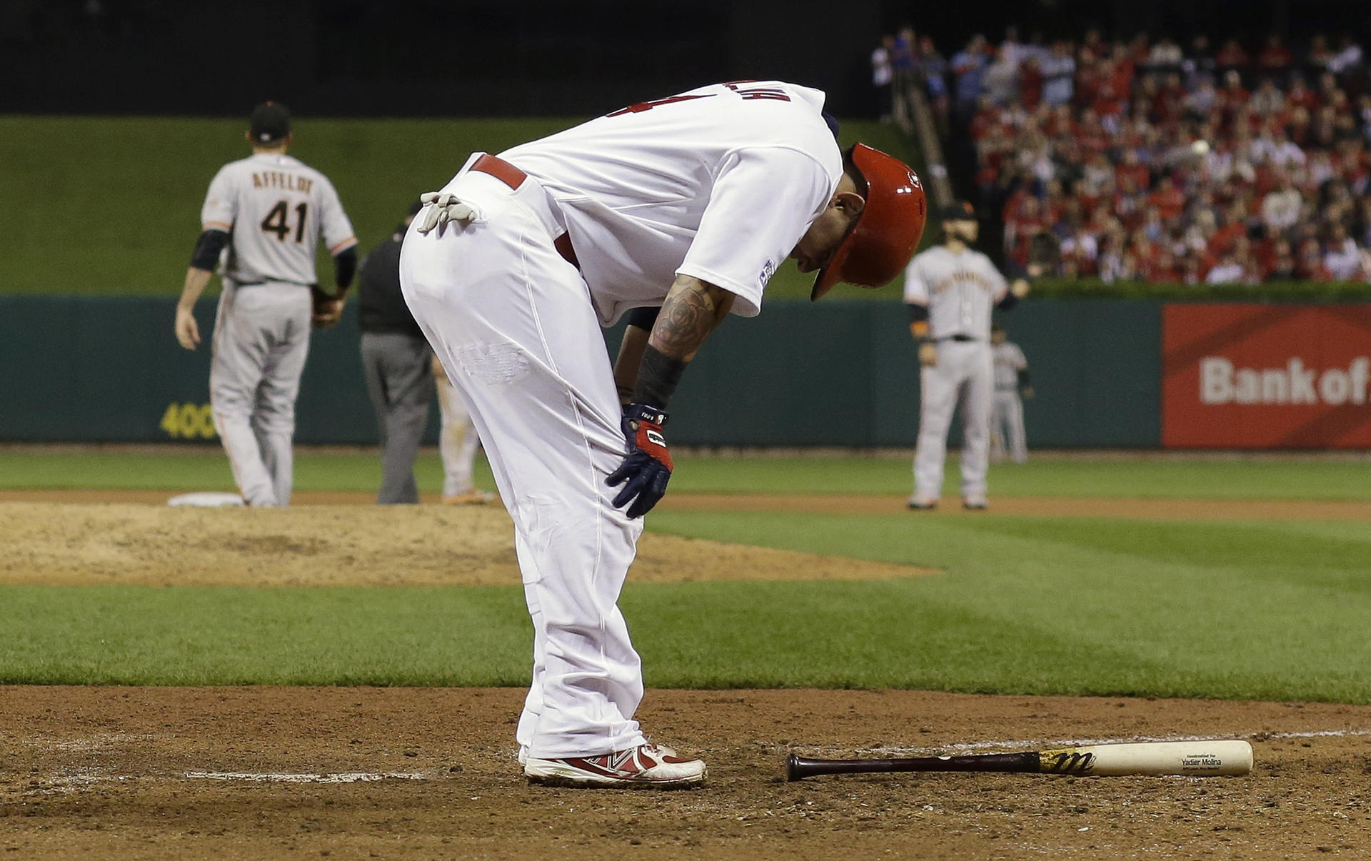 Cardinals' star catcher Yadier Molina is injured in the sixth inning against the Giants. Photos: AP