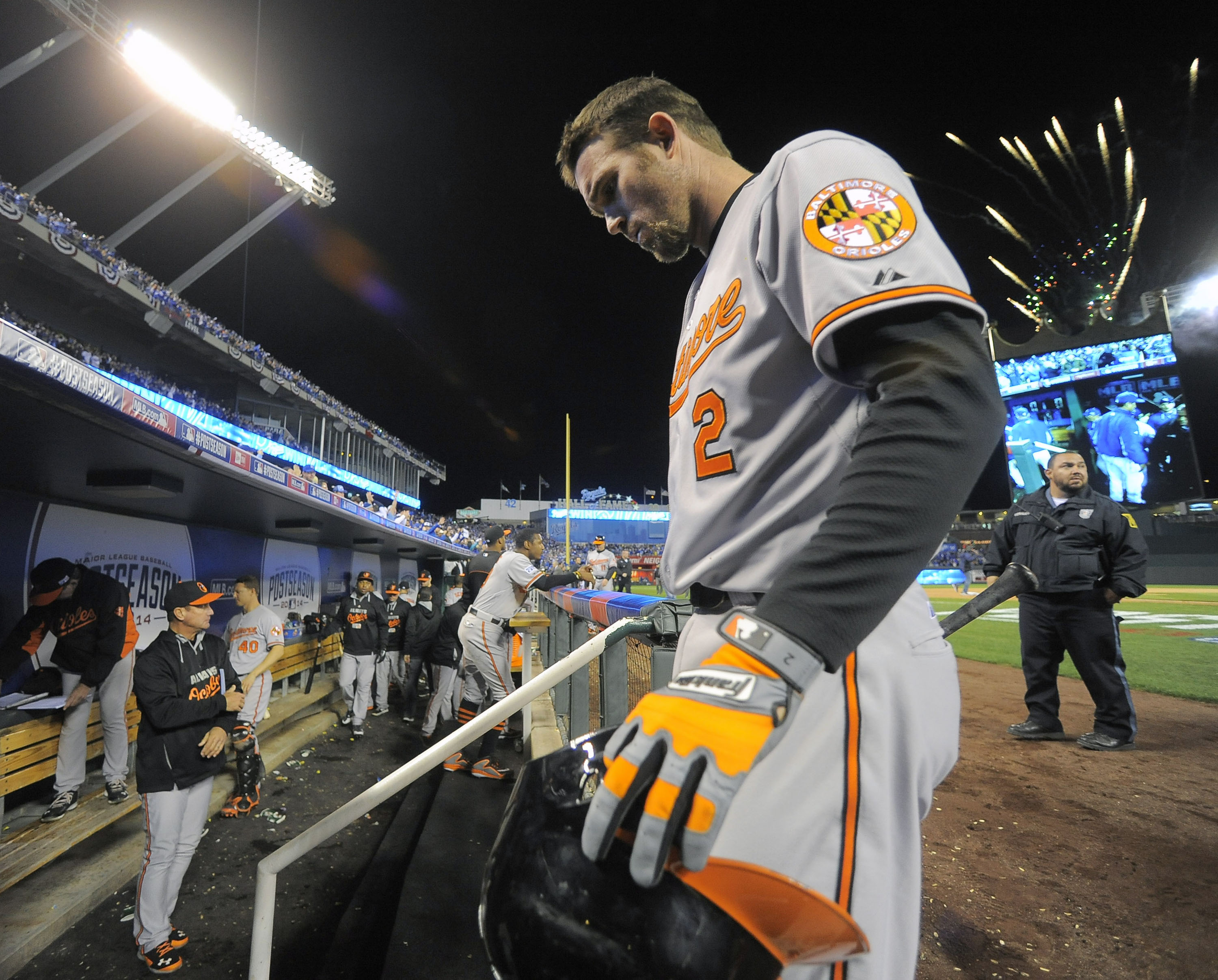 The Baltimore Orioles' J.J. Hardy returns to the clubhouse as fireworks shoot above the ballpark while the Kansas City Royals celebrate a 2-1 win in game three of the American League Championship Series. Photo: MCT  