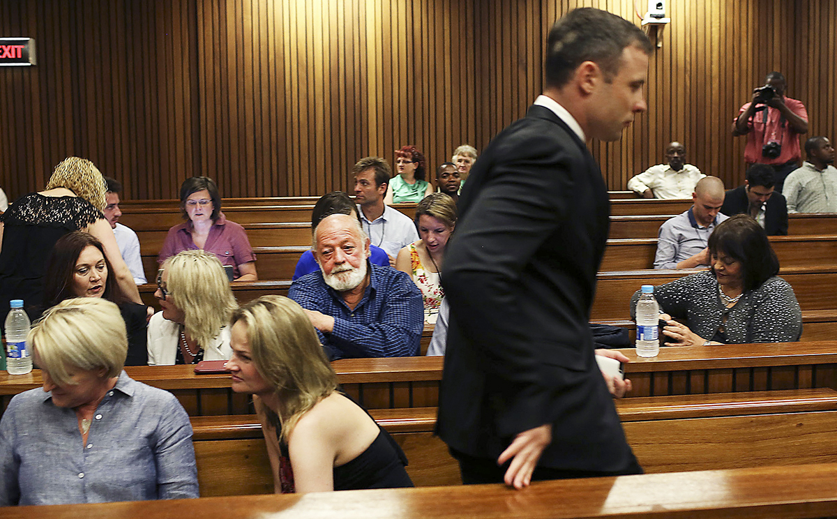 Oscar Pistorius passes by members of the Steenkamp family as he arrives for the fourth day of sentencing proceedings in the High Court in Pretoria. Photo: AP