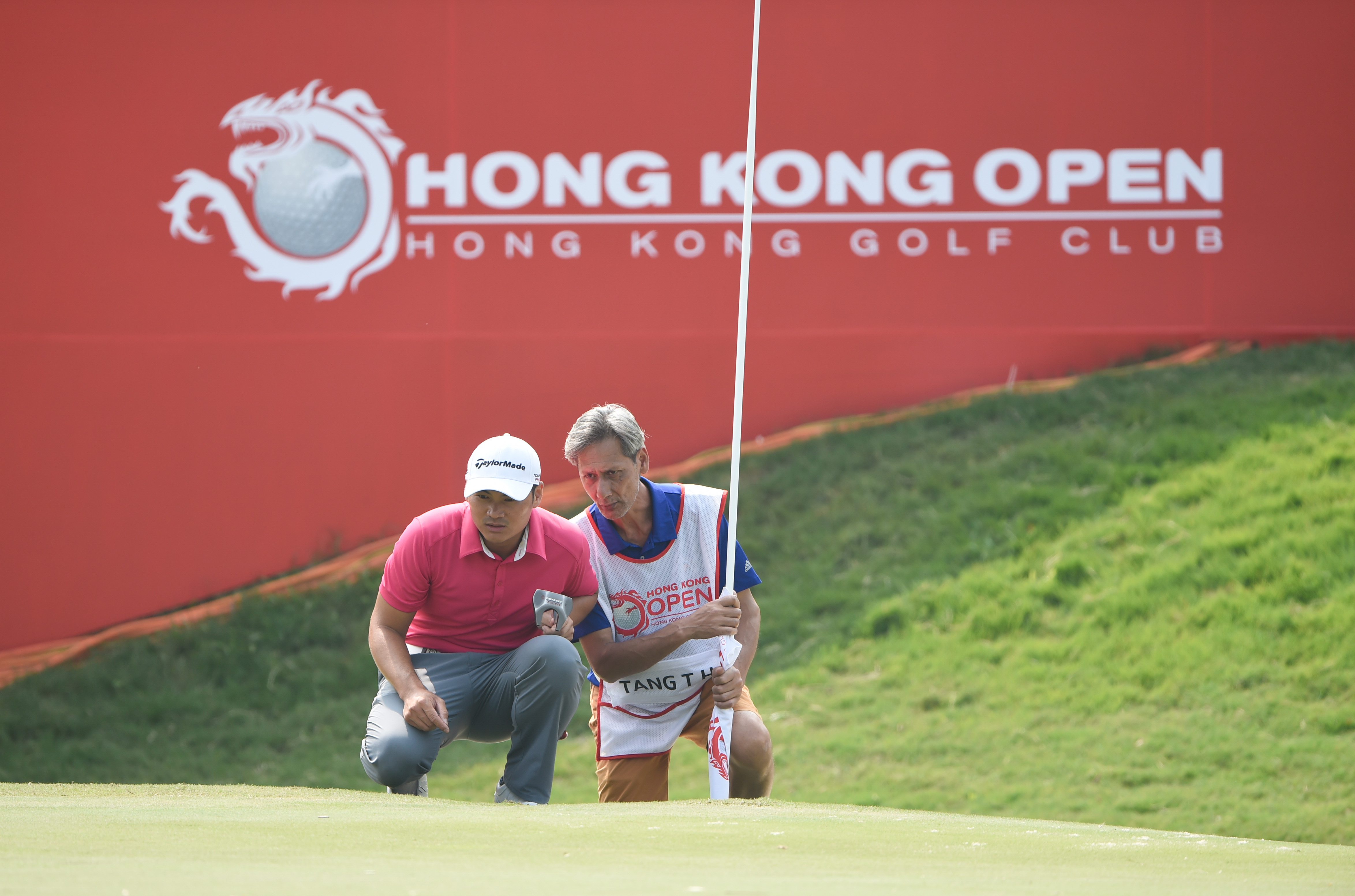 Timothy Tang discusses the layout with his caddie in the first round of the Hong Kong Open. Photo: Richard Castka