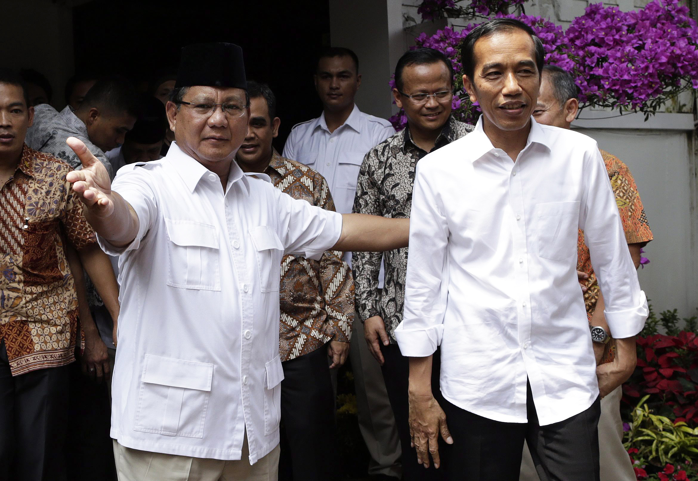 Indonesian president-elect Joko Widodo (right) is greeted by losing candidate Prabowo Subianto shortly after their meeting in Jakarta on Friday. Photo: EPA