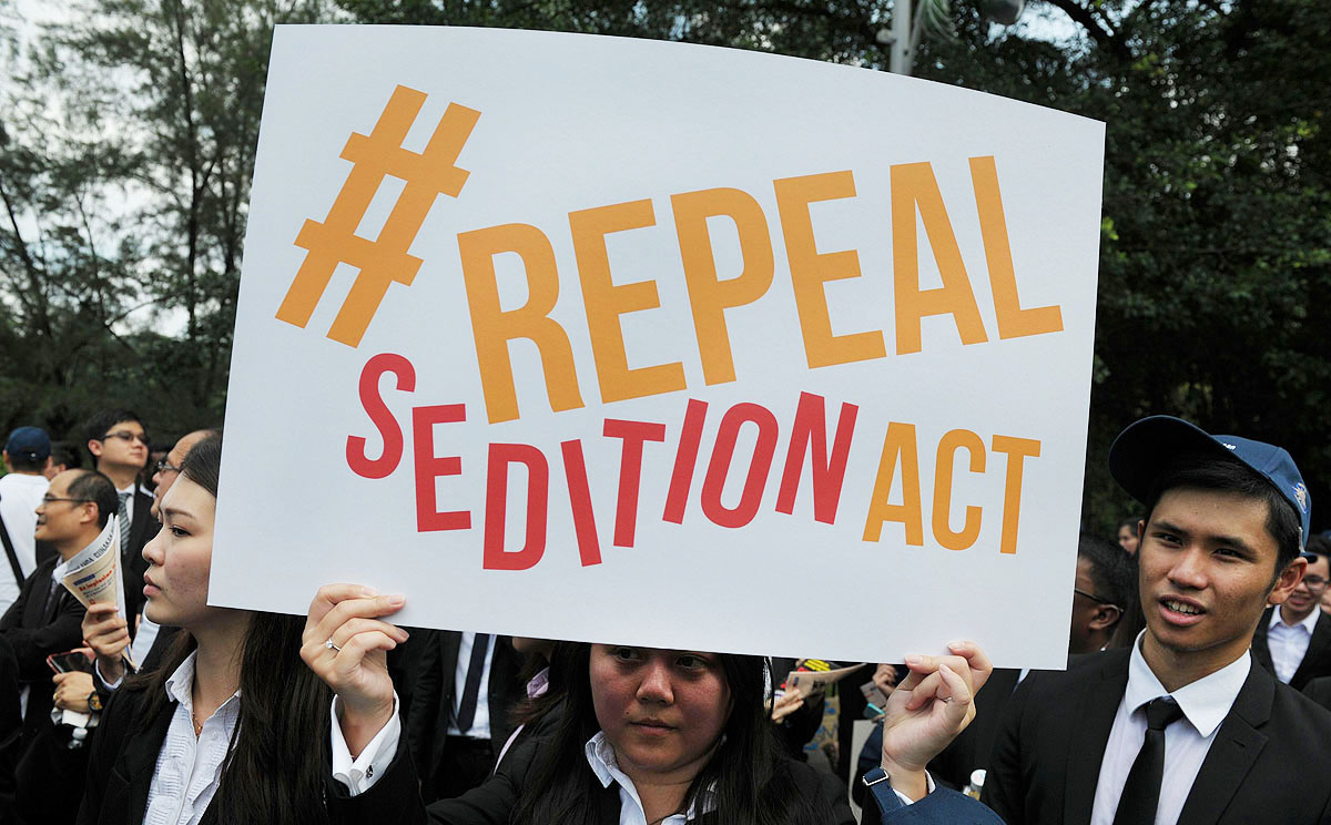 A Malaysian Lawyer holds a placard outside the Parliament in Kuala Lumpur during a rally to repeal the Sedition Act. Photo: AFP