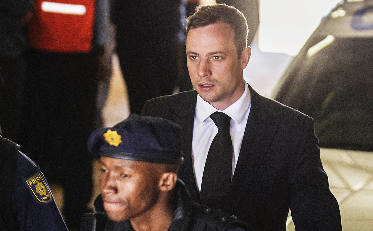 South African police lead Paralympic athlete "Blade Runner" Oscar Pistorius into an armoured vehicle headed for Pretoria Central Prison yesterday. Photo: AFP