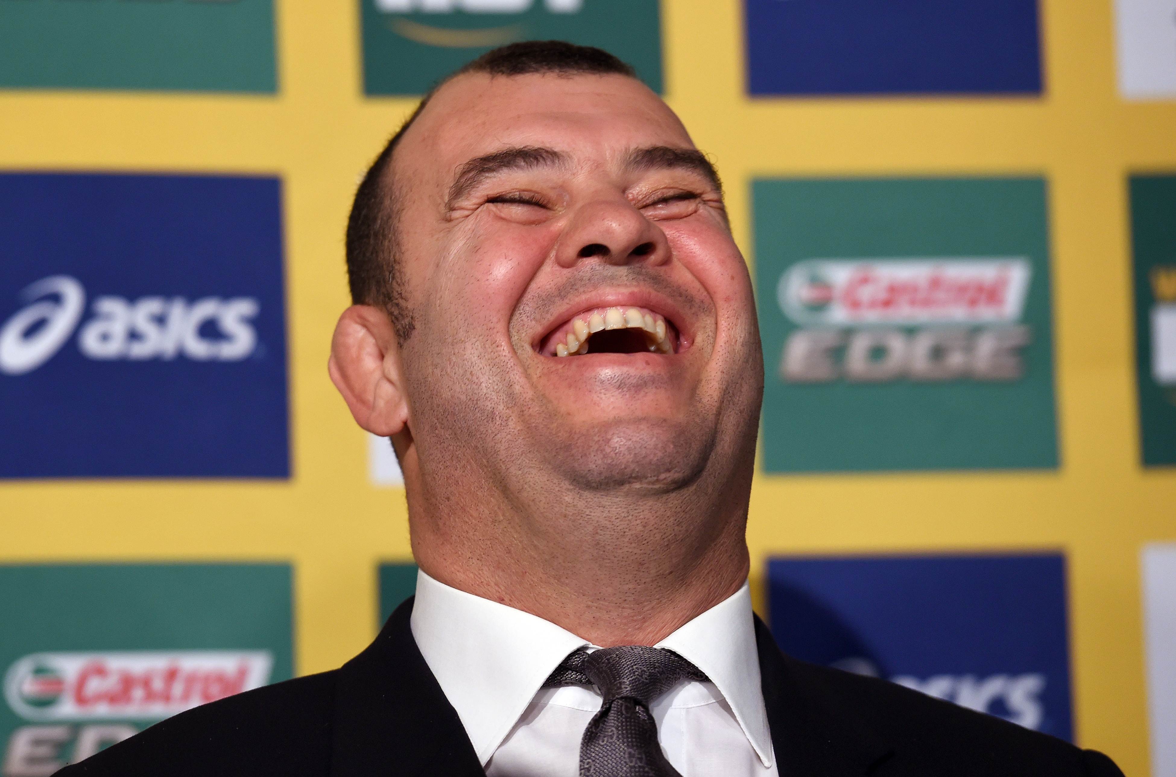 A beaming Michael Cheika after his appointment as Wallabies coach. Photos: AFP 