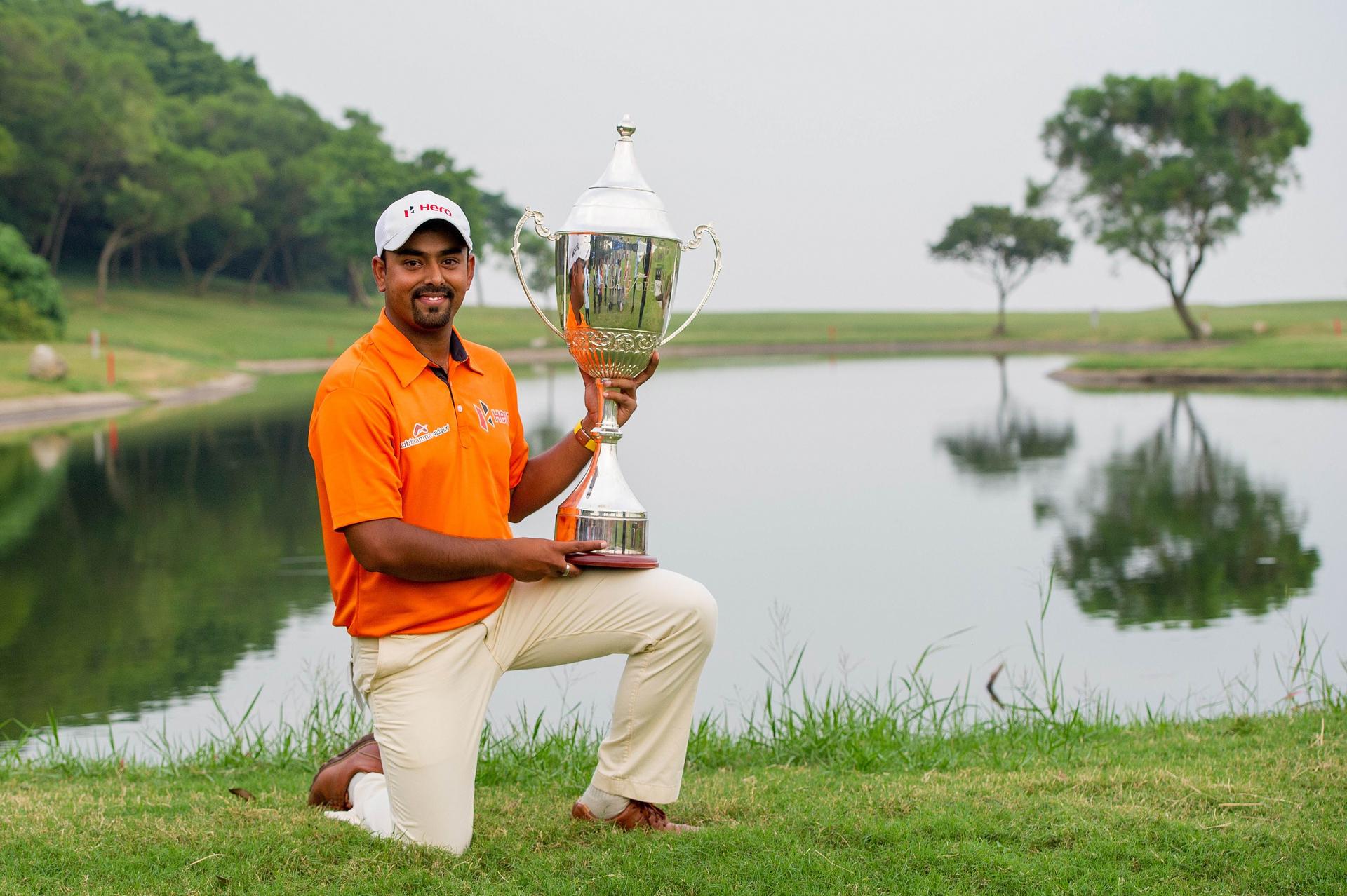 Anirban Lahiri of India with the spoils of victory after edging Scott Hend to win the Venetian Macau Open. Photos: AFP