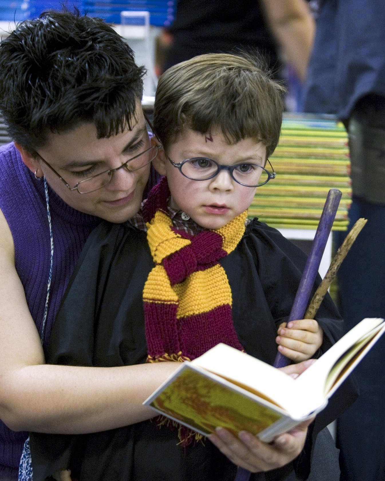 A woman and her son read Harry Potter and the Deathly Hallows. Photo: AFP