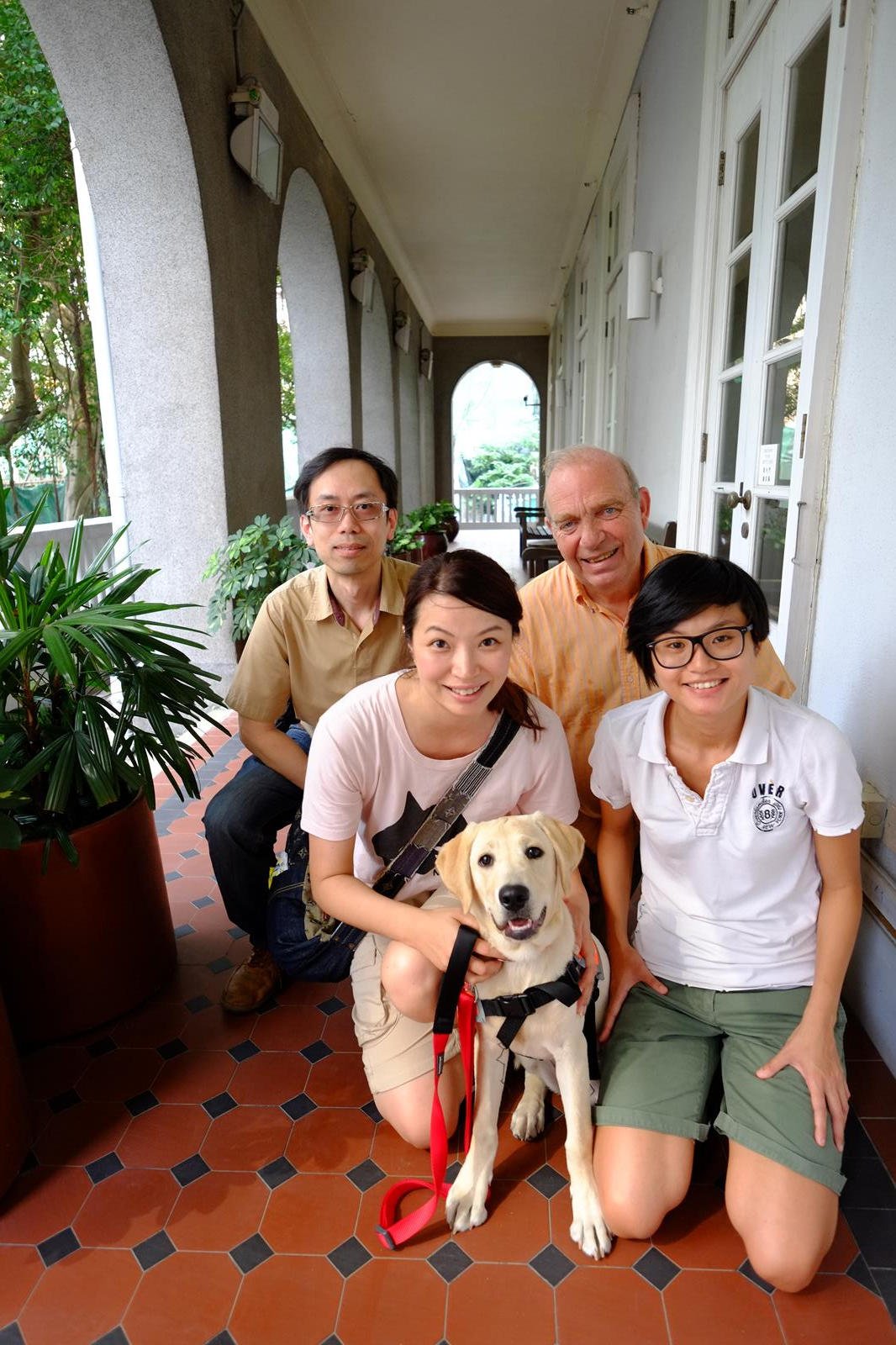 Lily Lam and labrador Bella with Hong Kong Guide Dogs Association staff (from left) Eddie Lee, Brian Francis and Fish Chan.