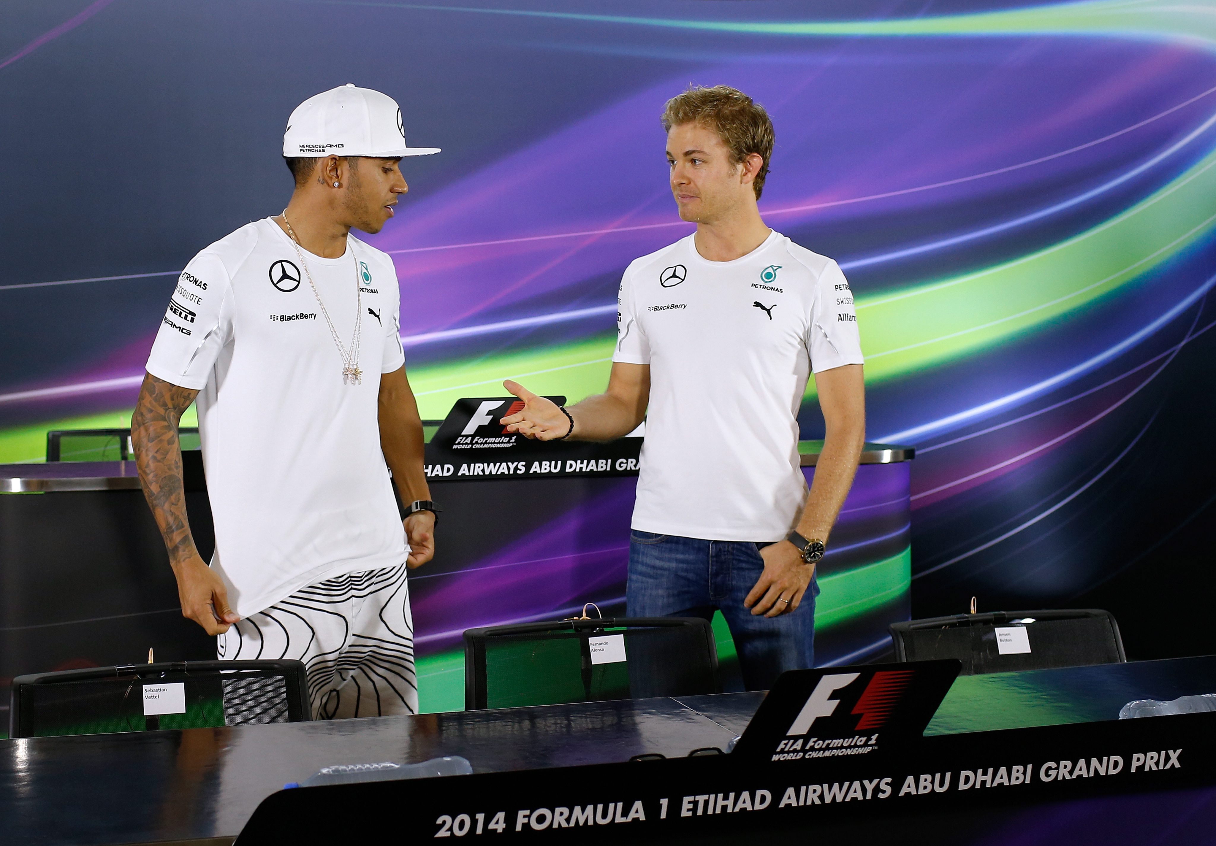 The body language between Lewis Hamilton and Nico Rosberg is not good before a posed handshake at a media conference on Thursday for Sunday's Abu Dhabi Grand Prix. Photo: EPA