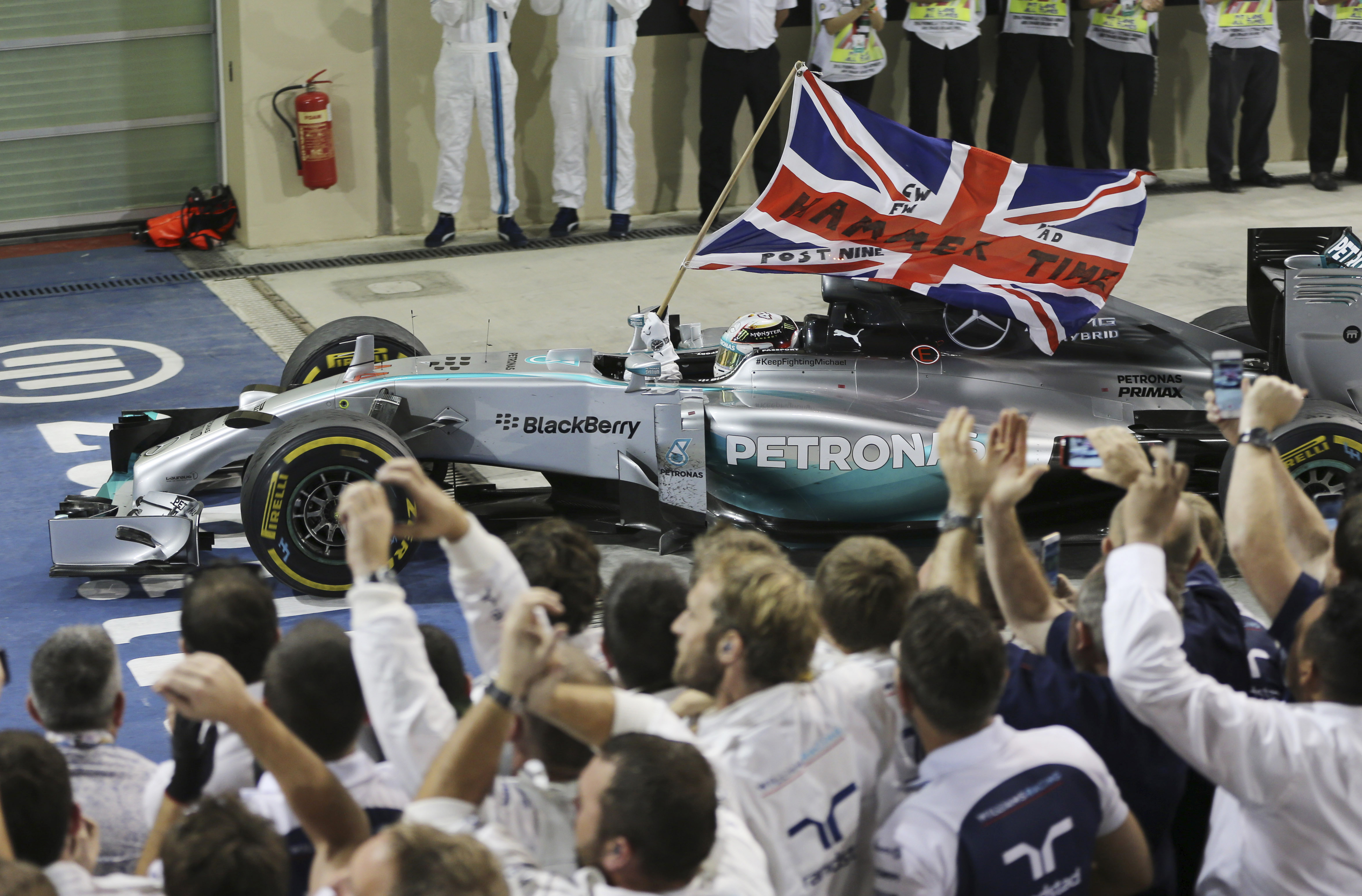 Mercedes' Lewis Hamilton celebrates winning the Abu Dhabi Grand Prix to clinch the Formula One world championship. Photo: AP