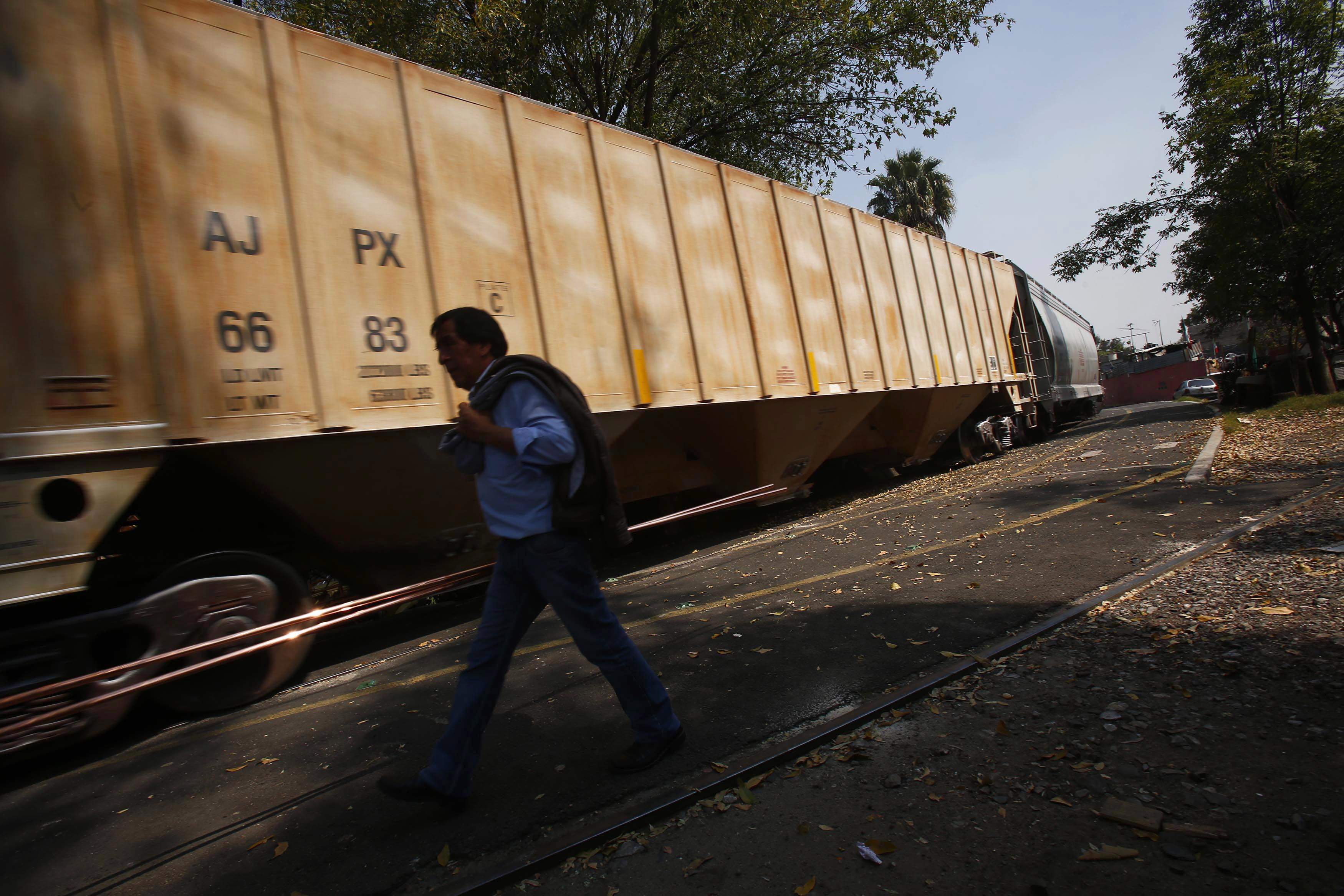 A freight train passes through Mexico City. It's not difficult to understand what led the government to change its mind about the high-speed rail project. Photo: Reuters