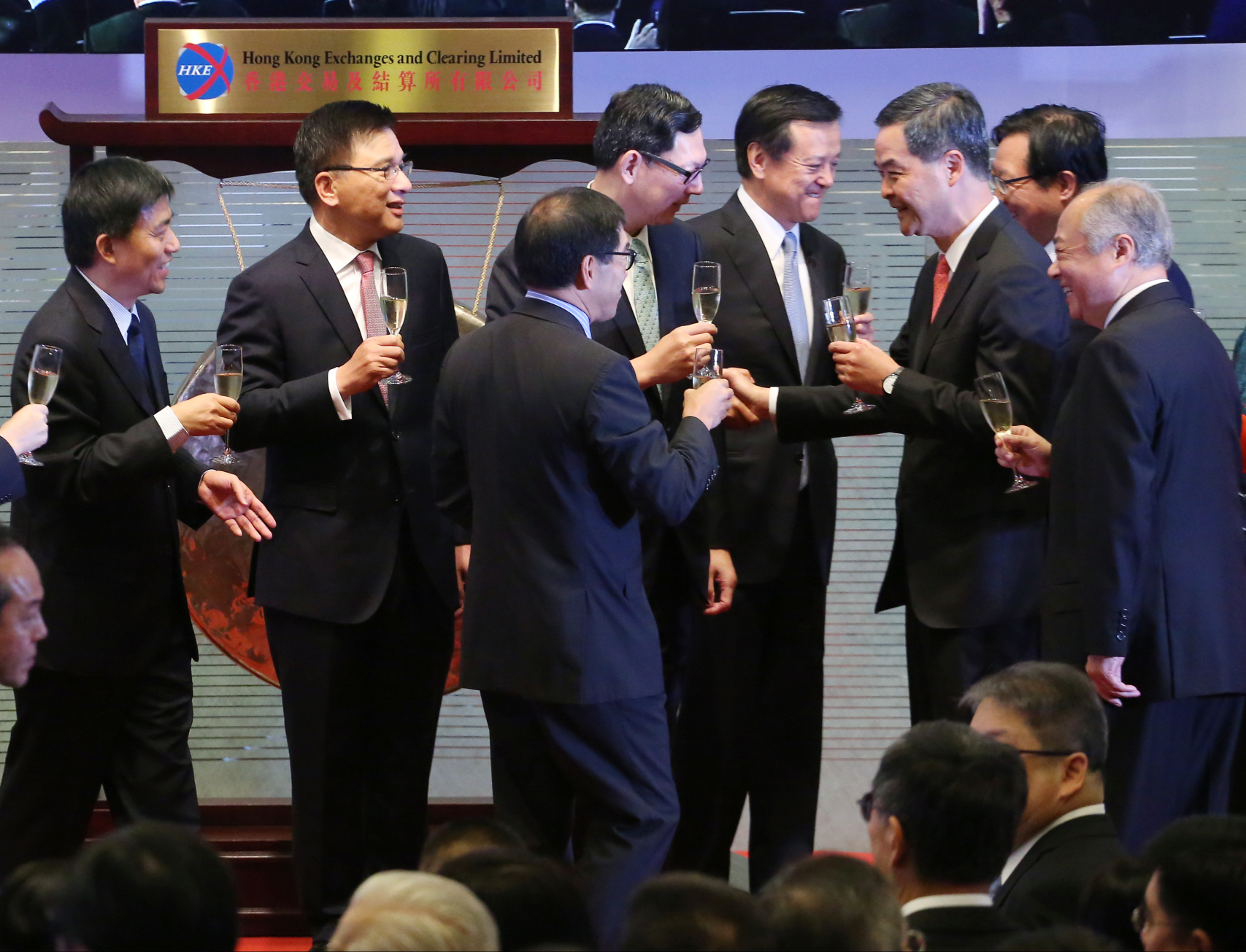 Executives from the Hong Kong and Shanghai bourses and government officials toast the launch of the stock through train. Photo: Felix Wong