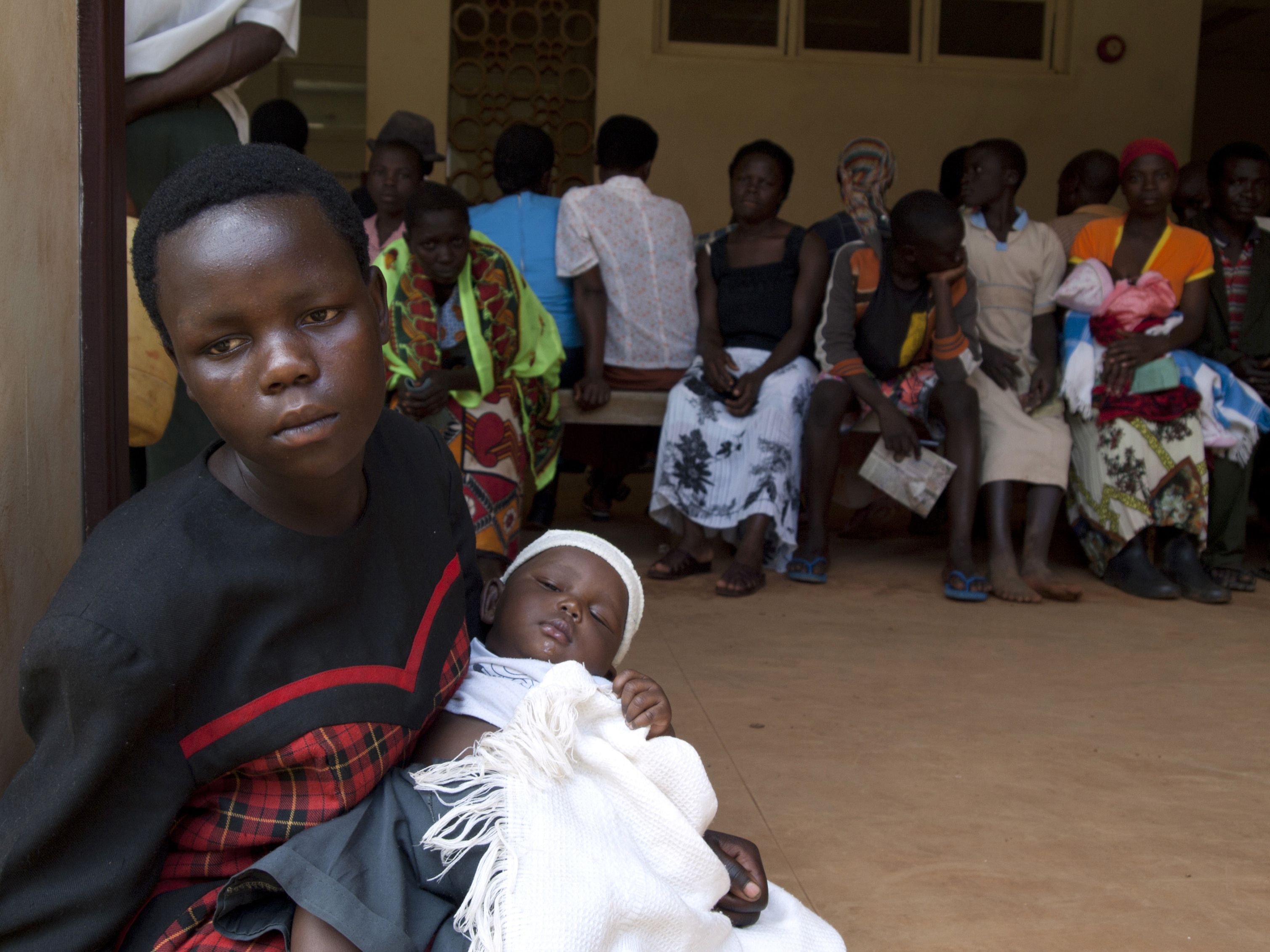 Women queue to get their babies tested for HIV in Uganda. Photo: AFP