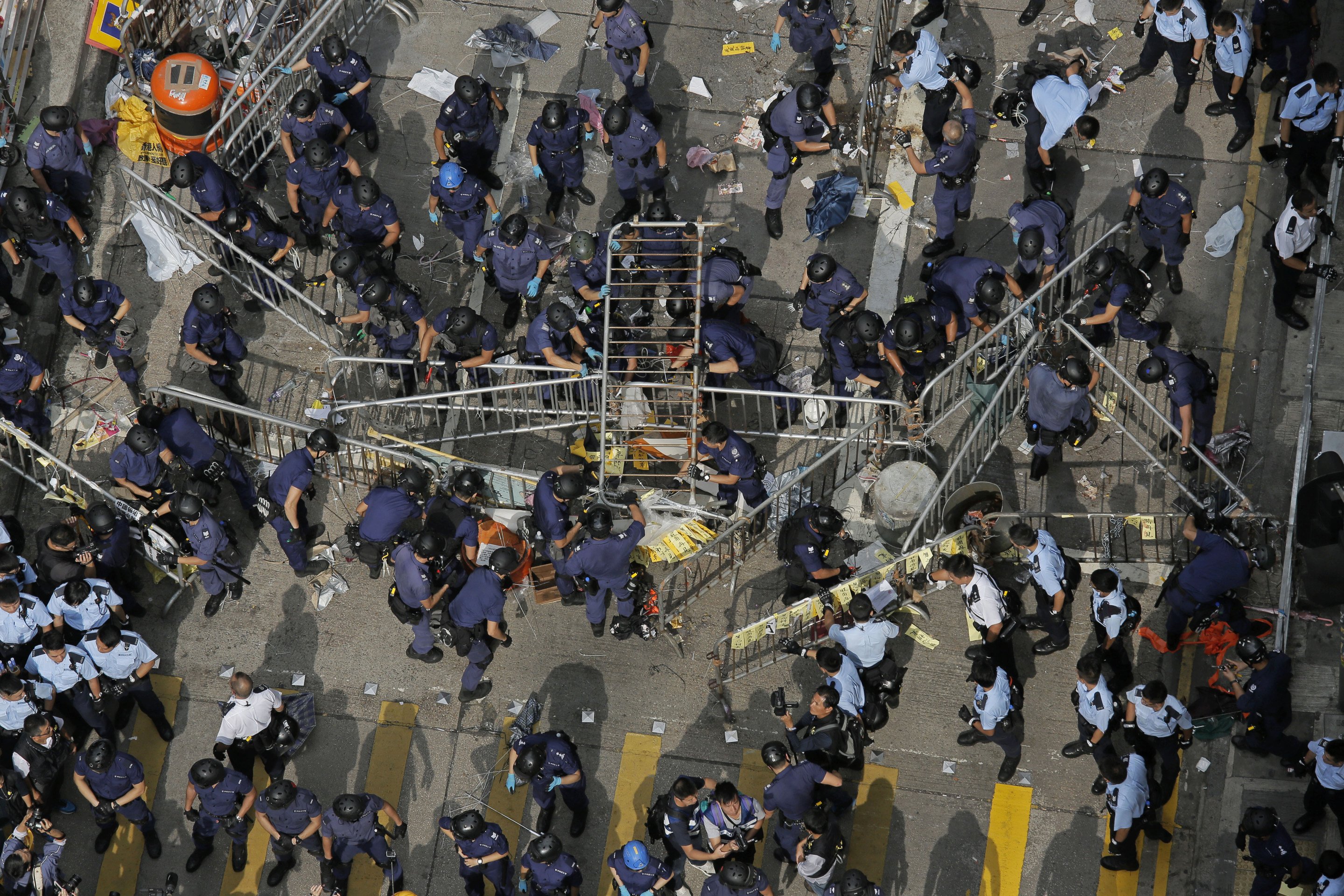 Police officers clearing the barricades in the Mong Kok occupied area last month. Photo: AP