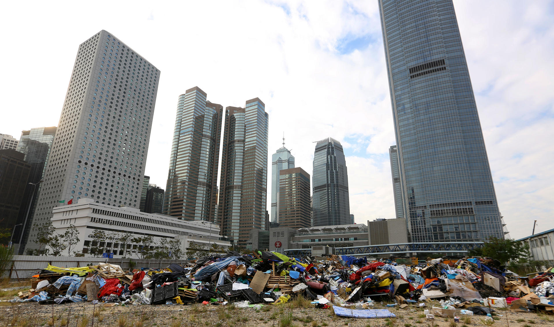 Tents, barricades and supplies from the Admiralty Occupy site lie dumped in a plot of land on the Central harbourfront yesterday, a day after the clearance. Photo: Edmond So