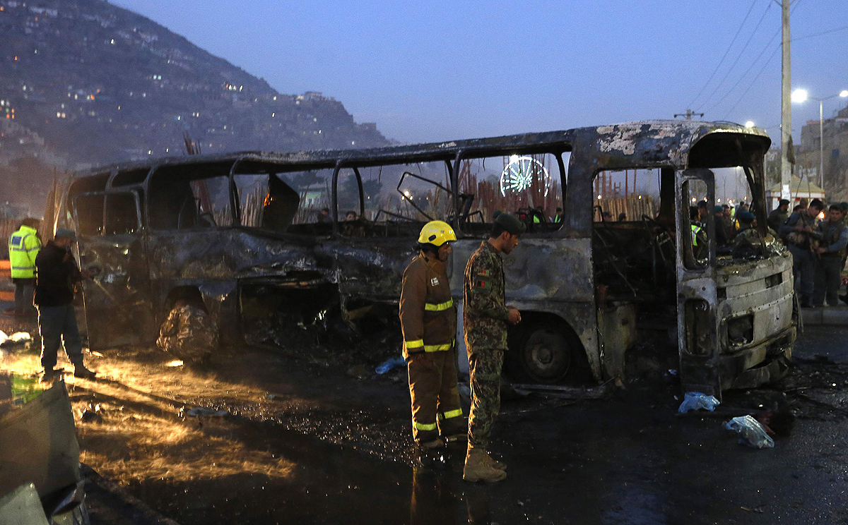 Afghan security forces inspect the site of a suicide attack on a military bus in Kabul on Saturday. Photo: Reuters