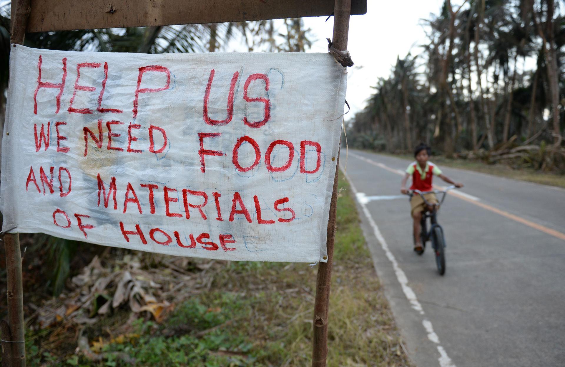 Help us: A sign at a village in Taft, east Samar, one of the Philippines' poorest regions and gateway for many of Asia's deadliest storms. Photo: AFP