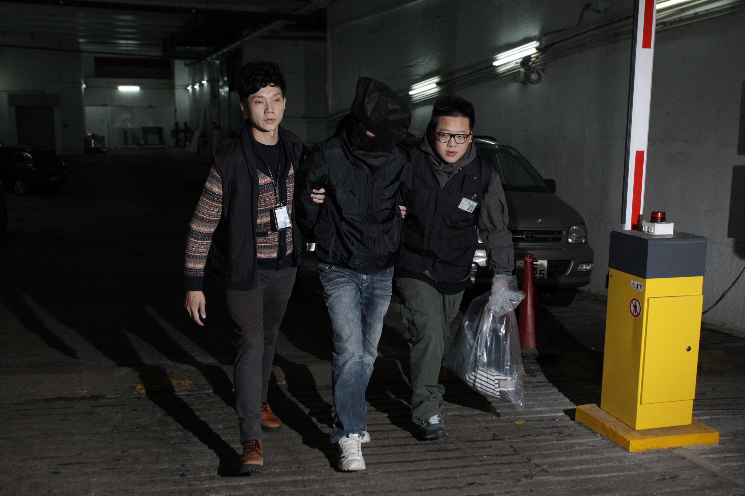 The hooded man is arrested in Kowloon Bay. Photo: Dickson Lee