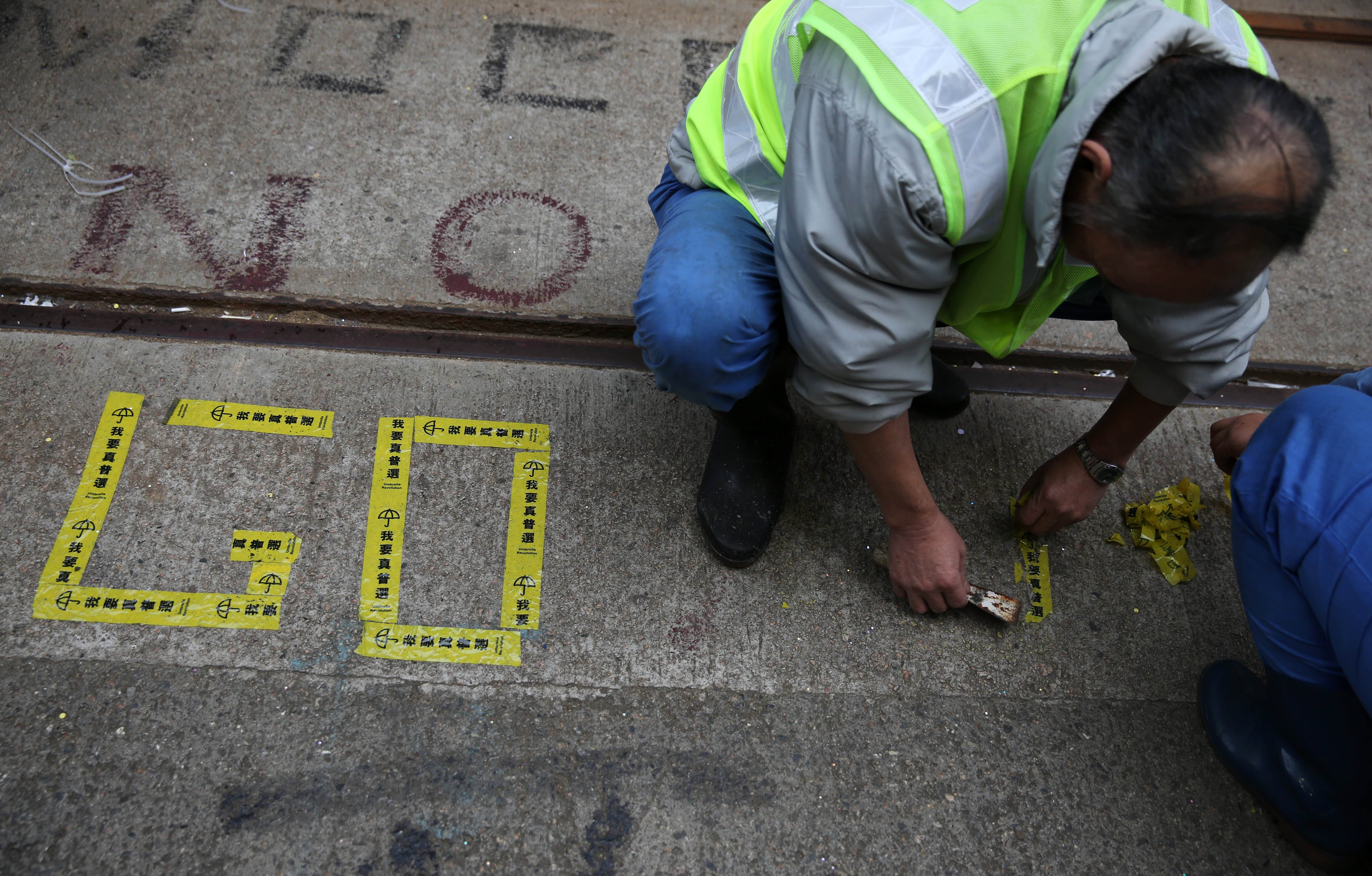 A cleaner cleaning up the protest site in Causeway Bay. Photo: AFP