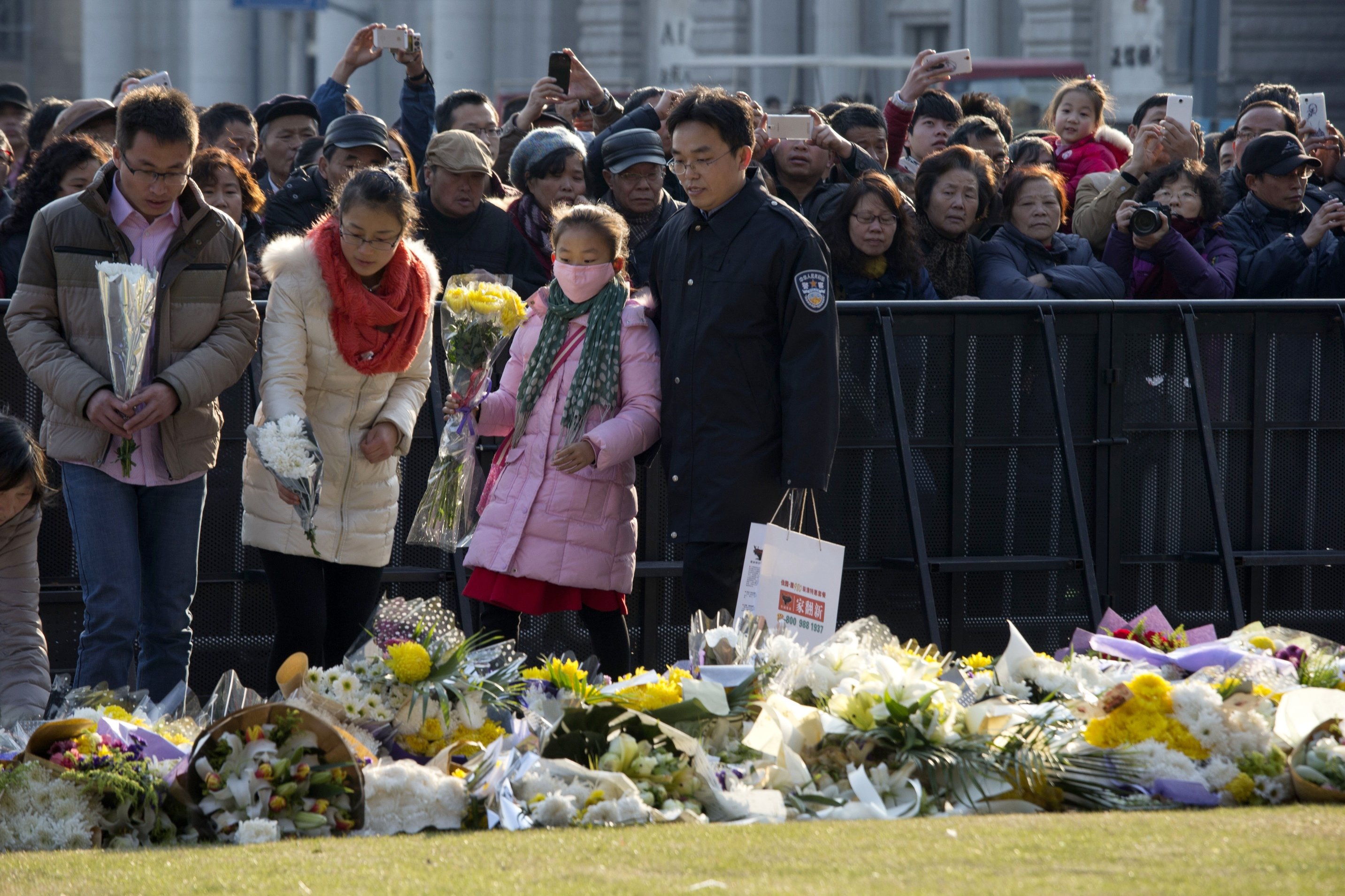 Residents lay flowers for victims of a deadly stampede in Shanghai. Photo: AP