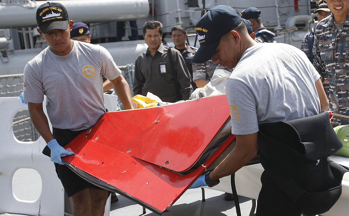 A piece believed to be part of the tailplane from AirAsia Flight 8501 is shown at the Indonesian Navy's Eastern Fleet Naval Base in Surabaya. Photo: AP