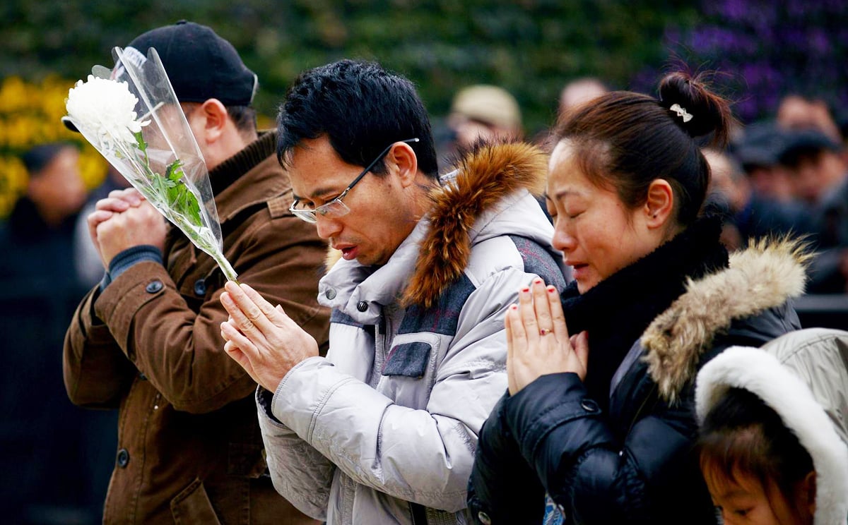 People pray for victims at the site of the stampede. Photo: AFP