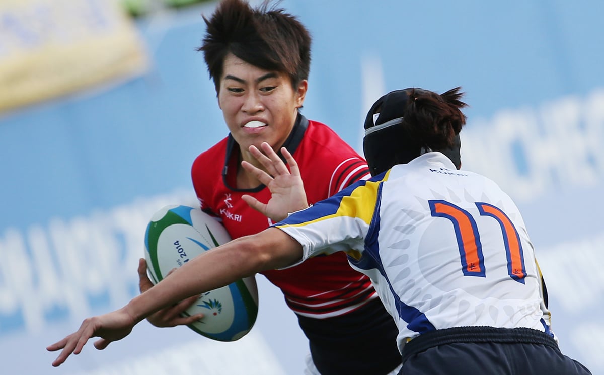 Hong Kong’s Aggie Poon Pak-yan, who came to rugby by way of the national sprint team, fends off a tackle from Liliya Bazyaruk of Kazakhstan during the 2014 Asian Games. Photo: Nora Tam/SCMP
