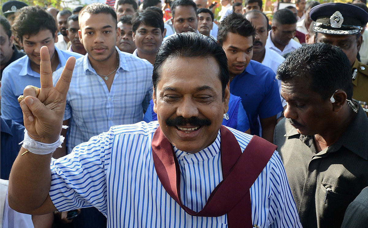 A confident President Mahinda Rajapaksa flashes a victory sign outside a polling station in his native town of Tangalla on Thursday. Photo: AFP