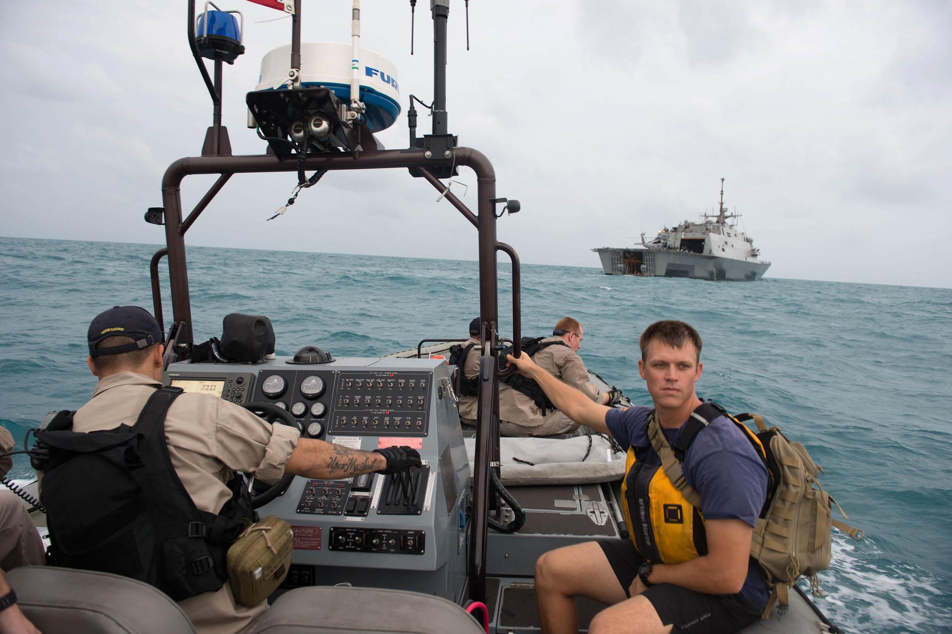 US Navy sailors help search for a missing AirAsia jet. Photo: AFP