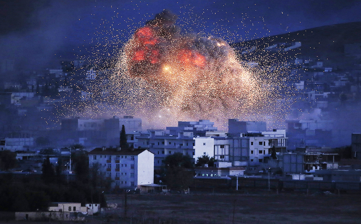 Thick smoke and flames from an explosion following an airstrike by the US-led coalition rise on Kobani. Photo: AP