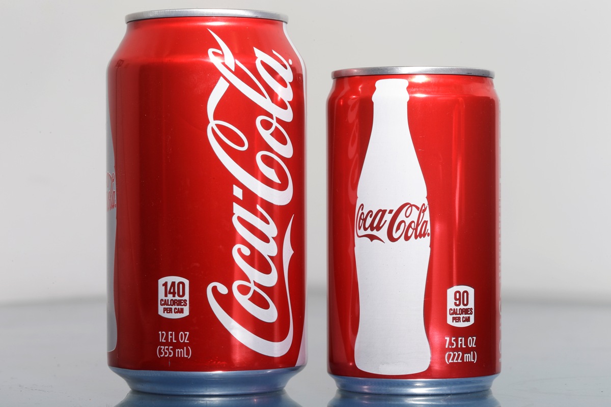 A 7.5-ounce can of Coca-cola (right) compared to a 12-ounce can.