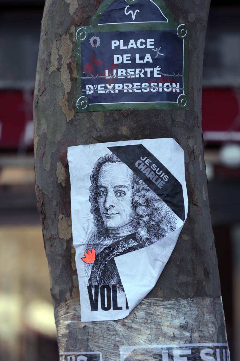 A poster that reads in French, "Square of Liberty and expression", and showing an image of the Enlightenment writer Voltaire on a tree at the Place de la Republique in Paris. Photo: AFP