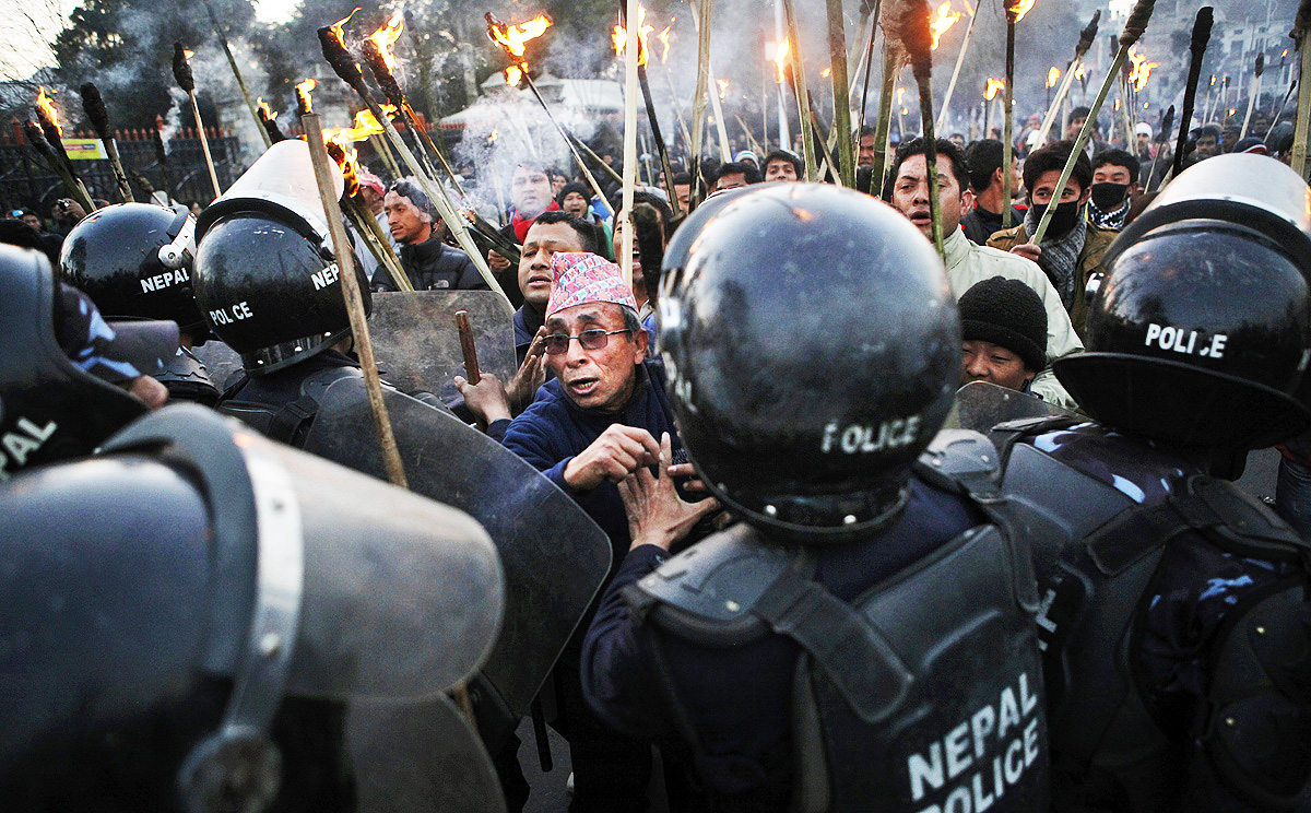 Nepalese police clash with demonstrators during a torch rally called by an opposition alliance of 30 parties in Kathmandu on Monday. Photo: AP