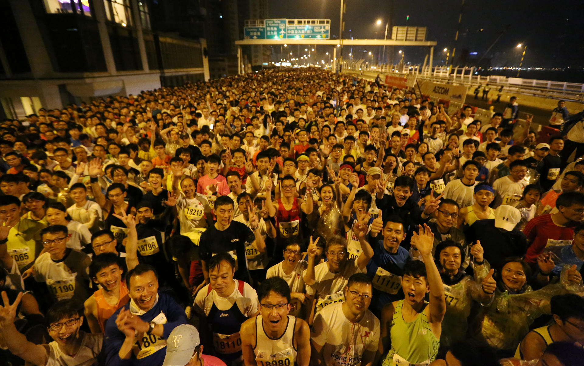 A swarm of competitors line up on the Island Eastern Corridor for the start of the hugely popular 10-kilometre events of the Hong Kong Marathon programme in the early hours of Sunday. Photo: Felix Wong