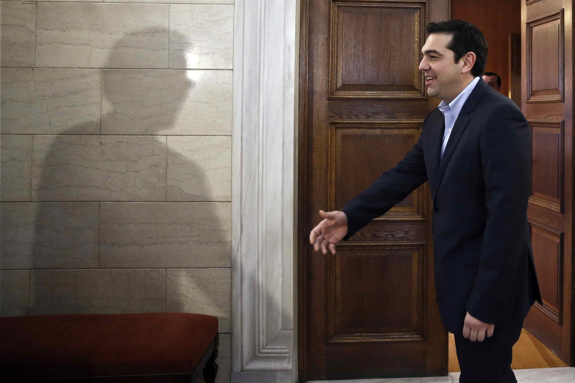 Shadow of Jeroen Dijsselbloem and Alexis Tsipras. Photo: Reuters