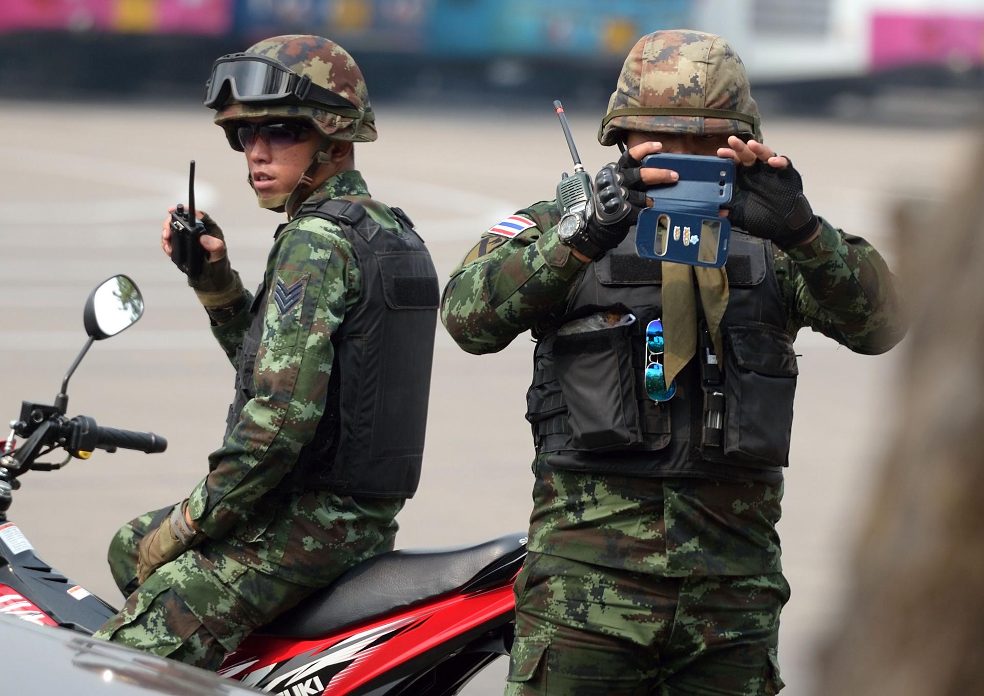 A Thai soldier takes pictures of members of the media, who are feeling more threatened by laws aimed at restricting their work. Photo: AFP