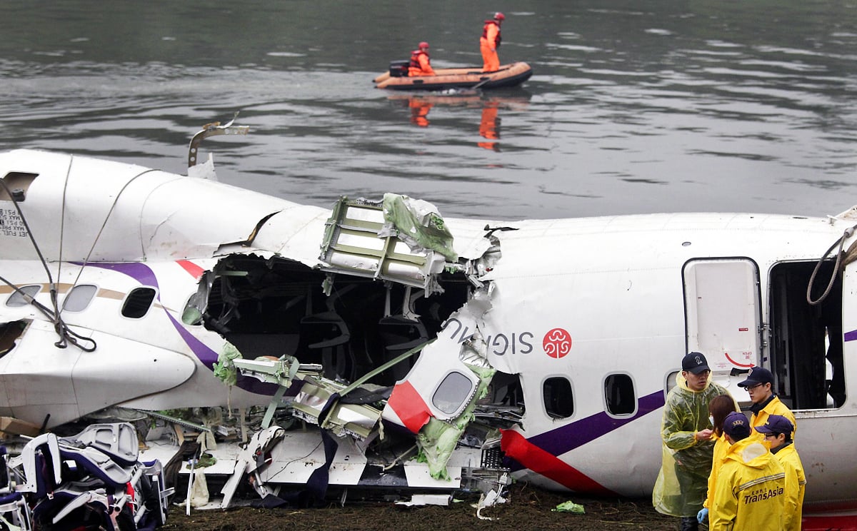 Members of a search-and-rescue team near the wreckage of the aircraft. Photo: AFP 