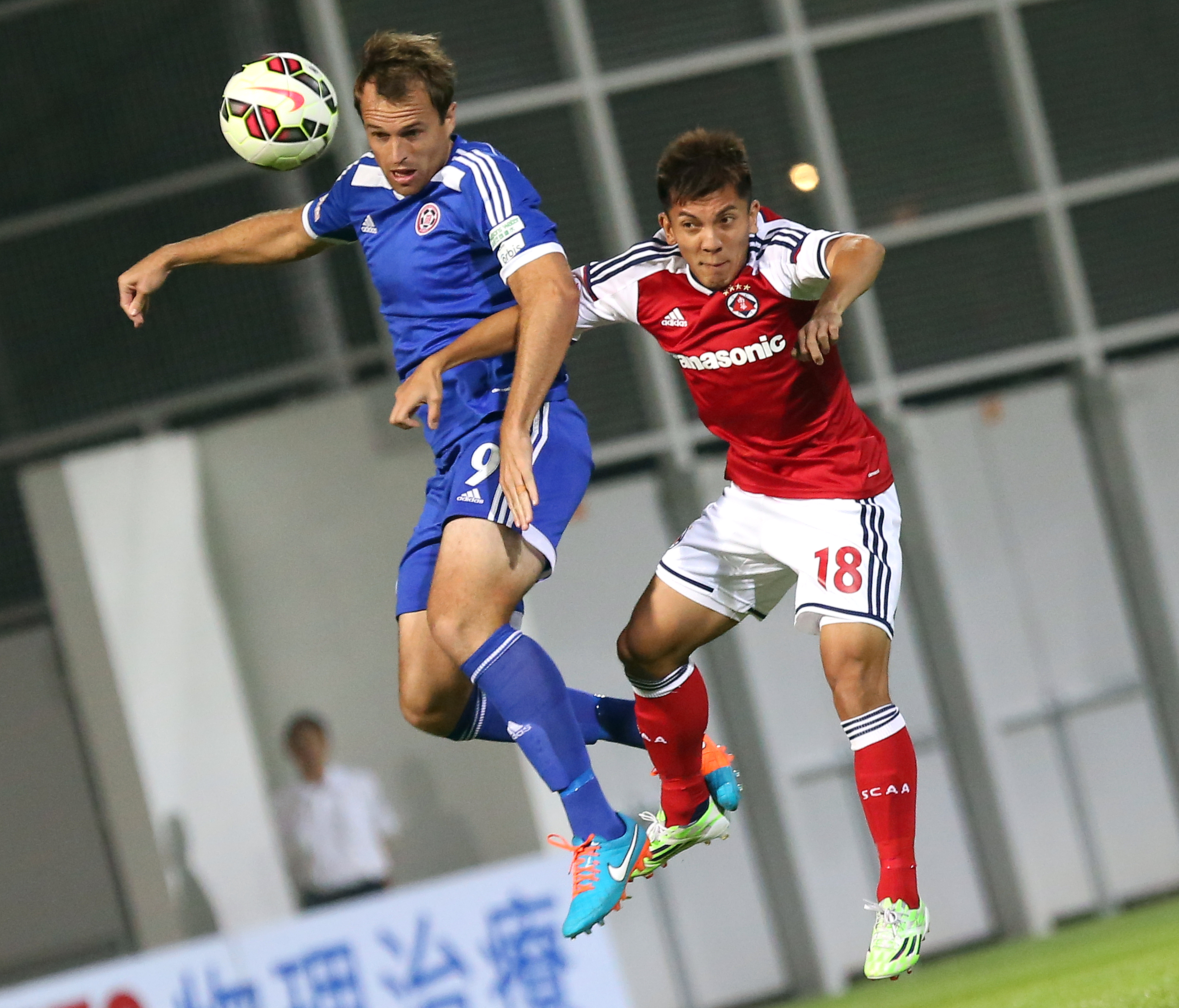 Eastern's Dylan Macallister (in blue) and South China's Kwok Kin-pong go for a header in a Hong Kong Premier League match at Mong Kok Stadium. Photo: Nora Tam