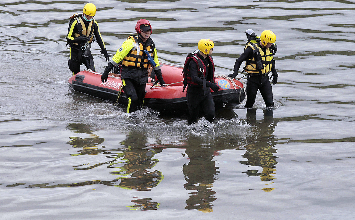 Rescue workers search the river near the crash site. Photo: AP 
