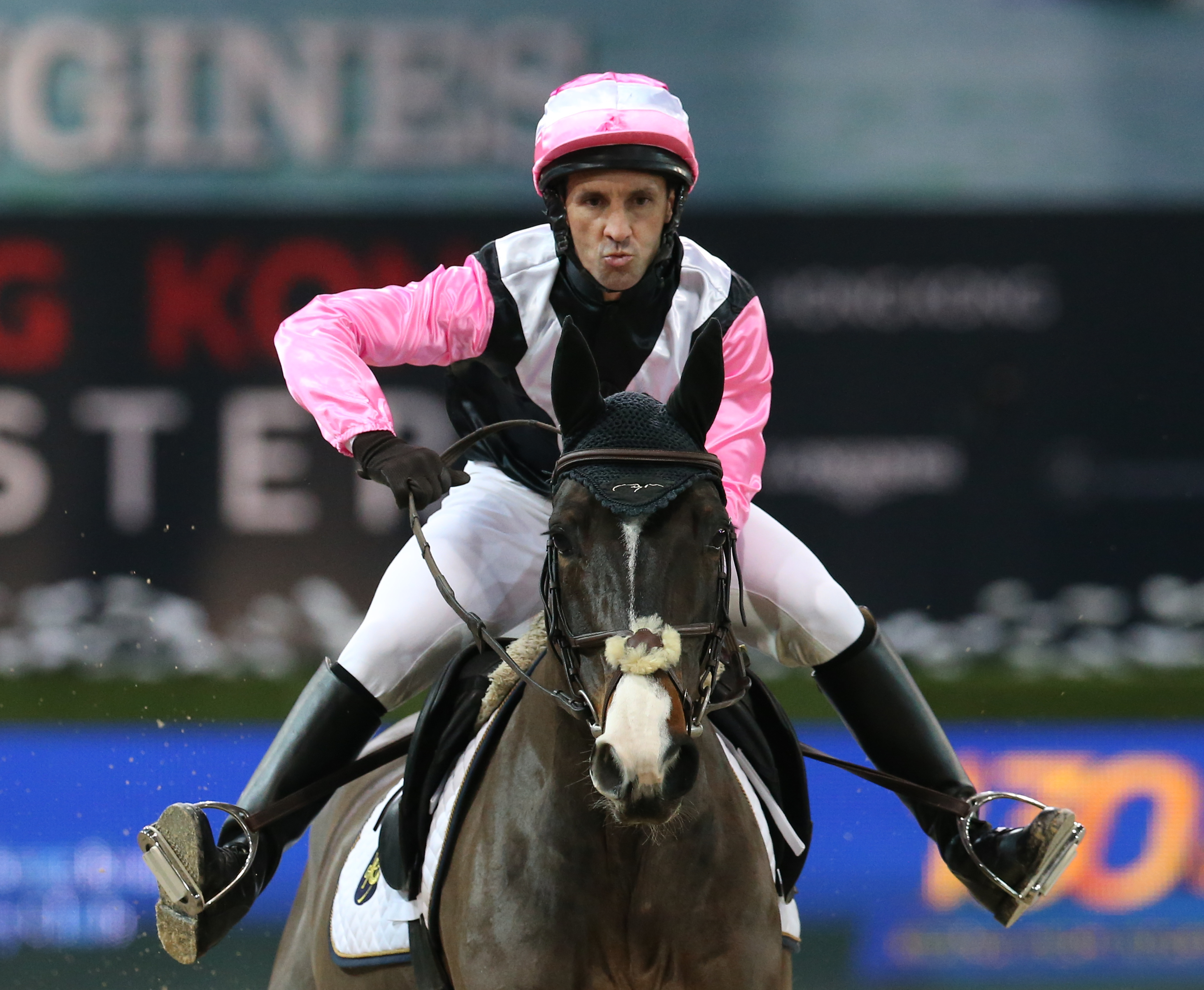 Irish jockey Neil Callan strikes an ungainly pose during the "Race of the Riders" at the Longines Hong Kong Masters at AsiaWorld-Expo. Photo: K.Y. Cheng